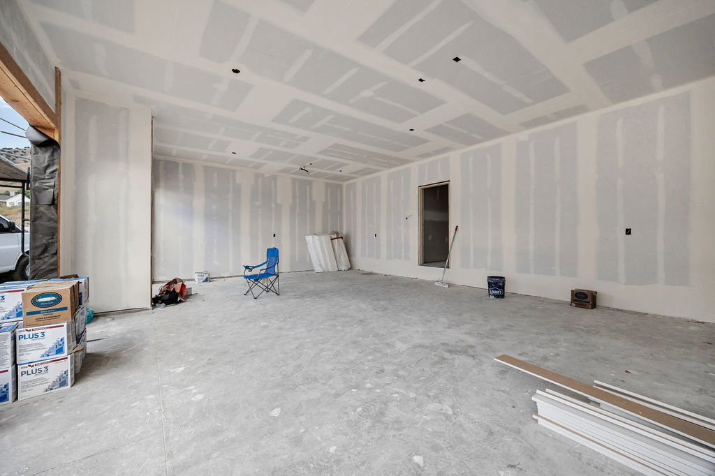 Spacious interior with unpainted drywall walls and ceiling