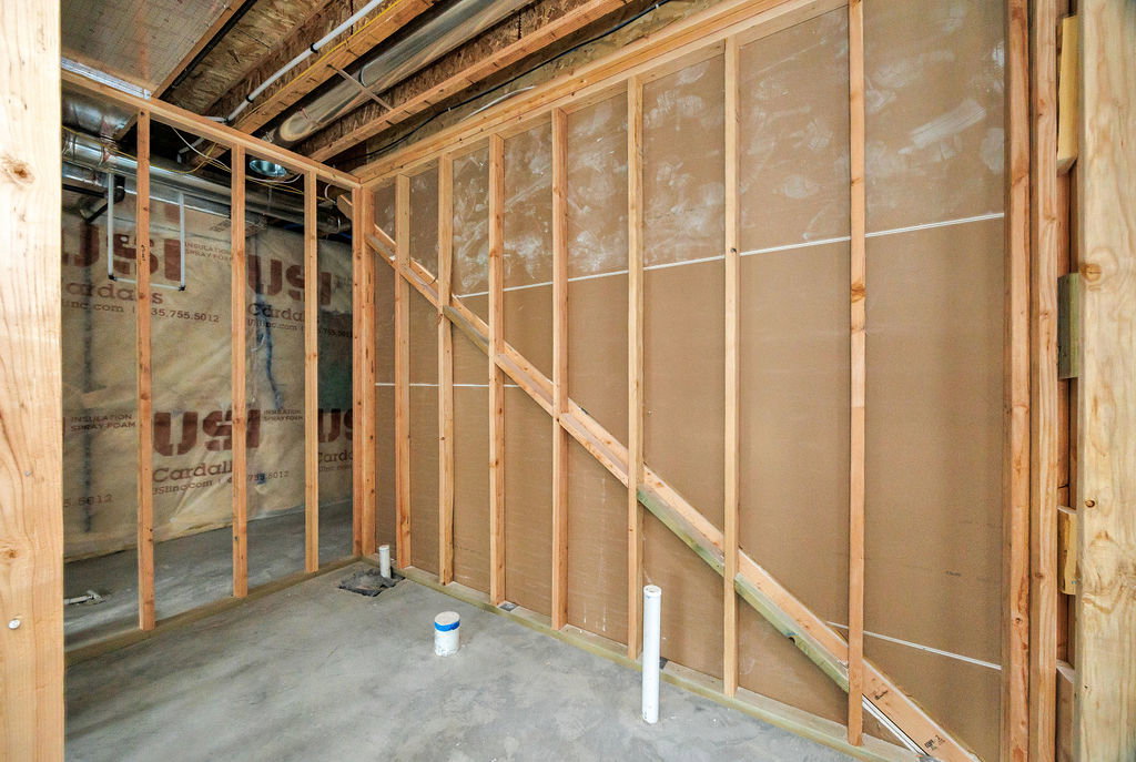 Framed interior space with a concrete floor and exposed ceiling joists