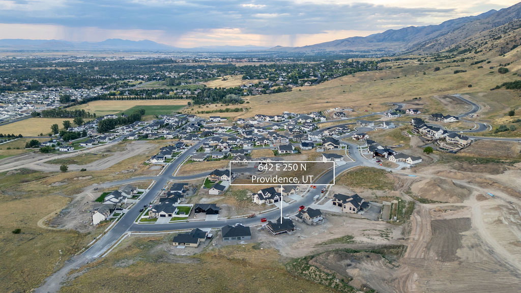 New construction development featuring a mountain backdrop and established residential areas nearby