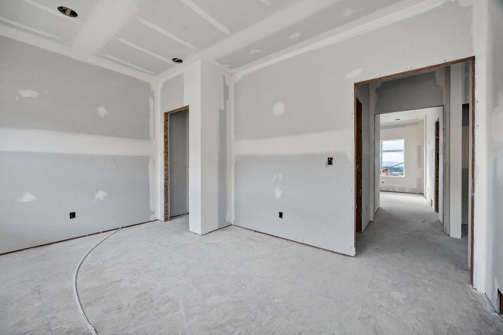 Interior space with exposed drywall and concrete subflooring