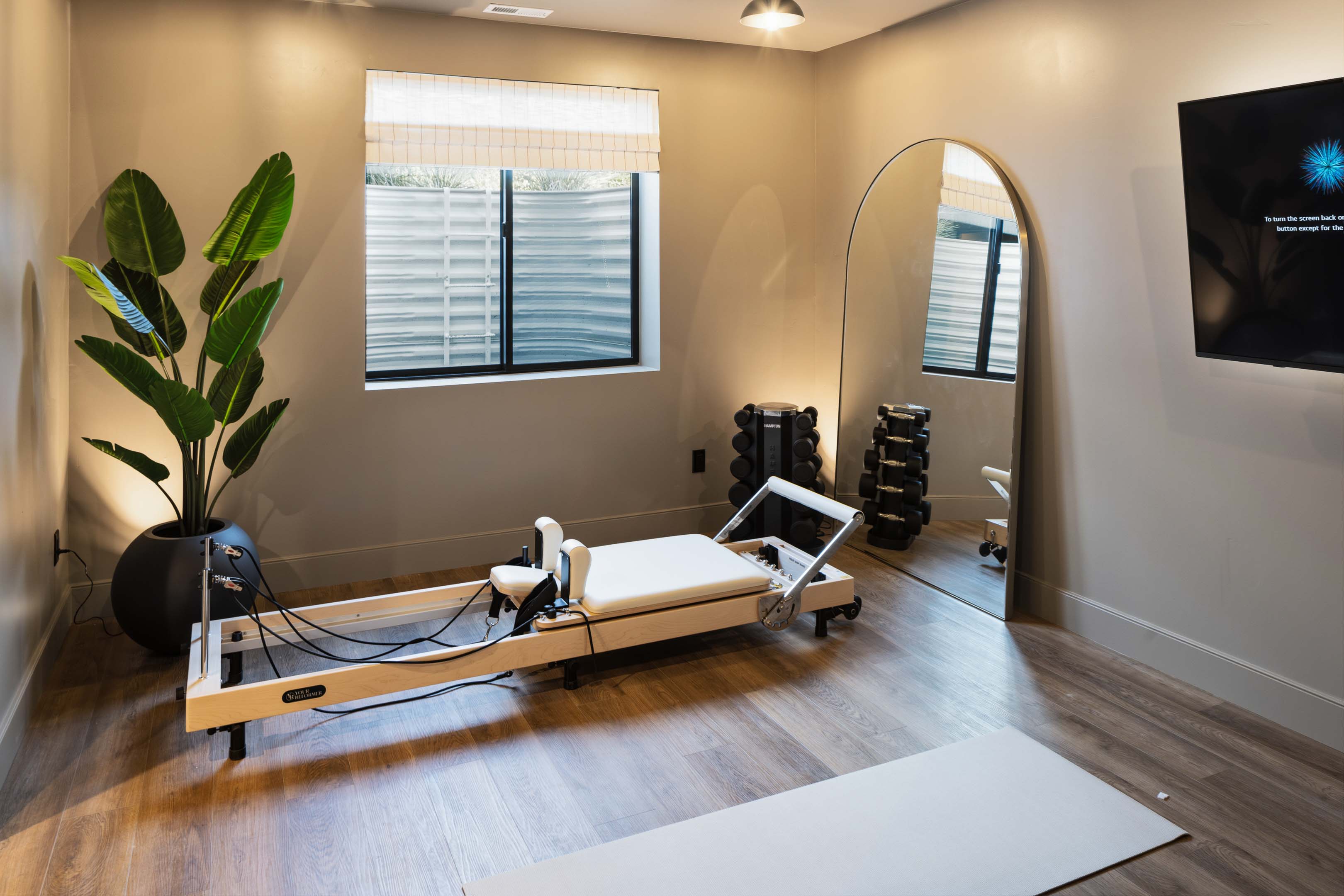 Finished space featuring wood-finish flooring, recessed lighting, and a wall-mounted media display