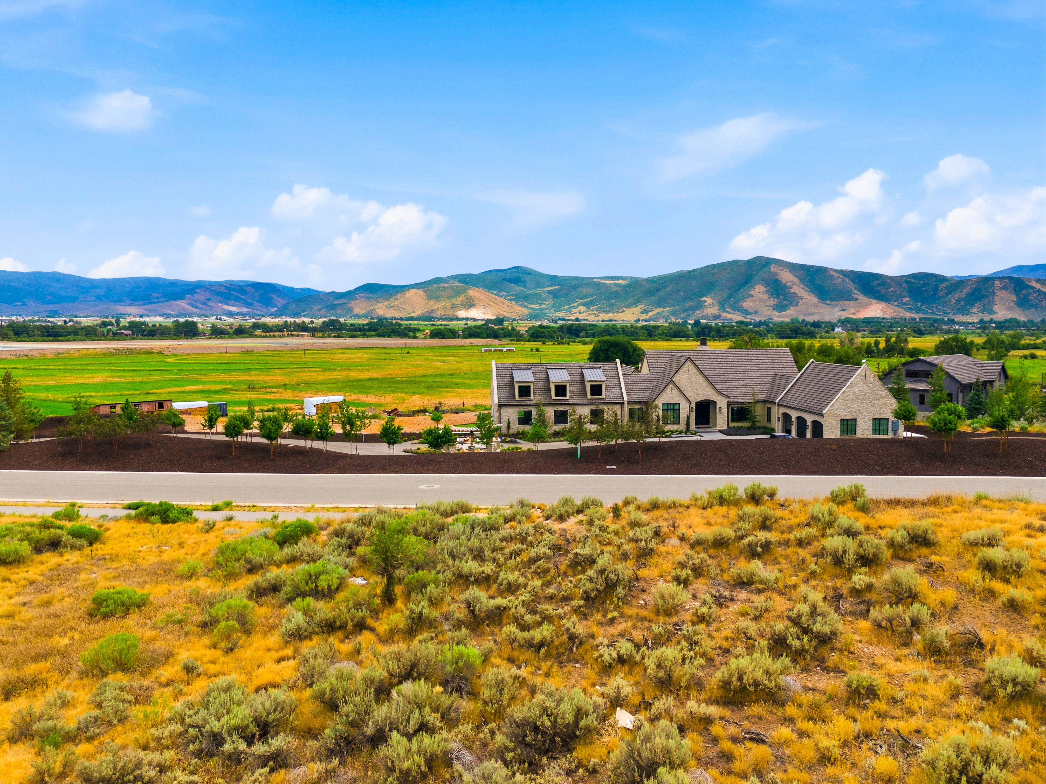 Expansive stone and stucco exterior with multiple gables and dormer windows