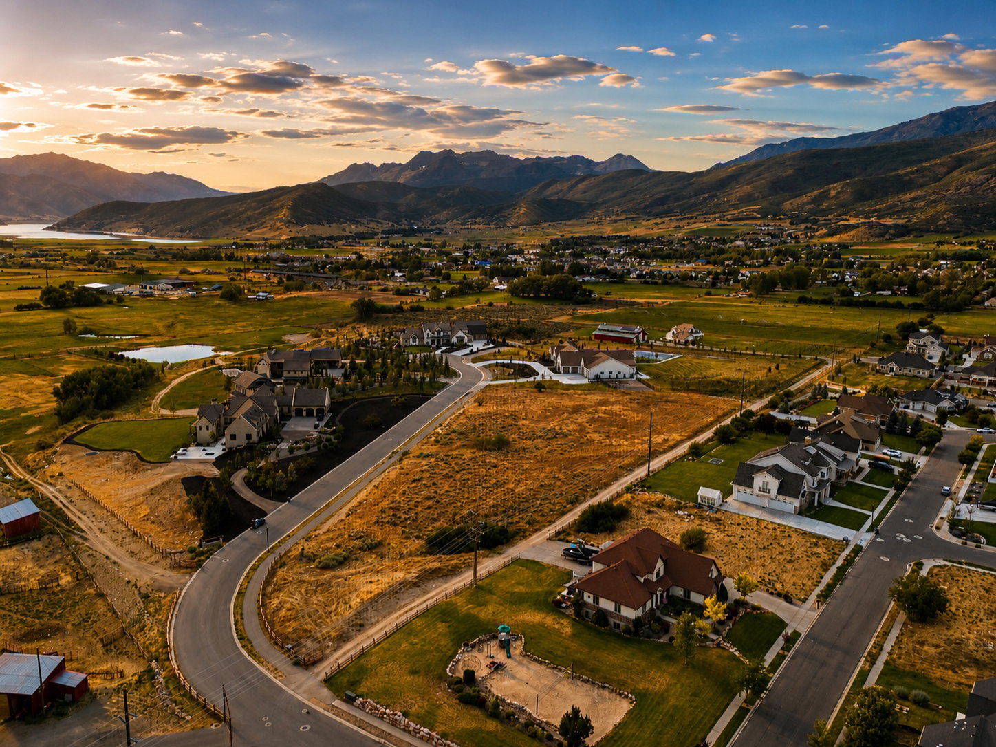 Expansive aerial view of a developing residential area with paved streets and established homes