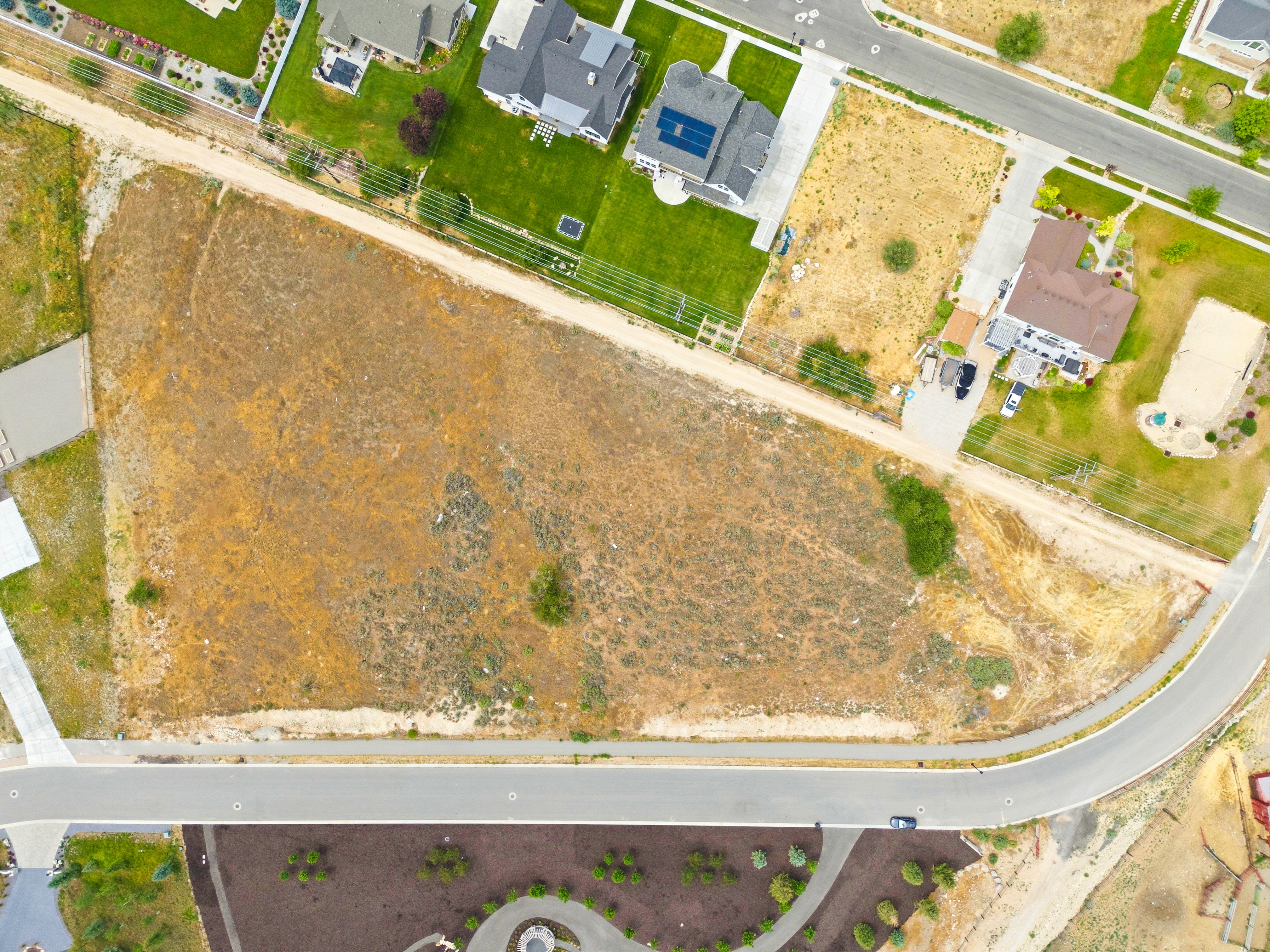 Expansive undeveloped parcel featuring direct road frontage and a curving street boundary