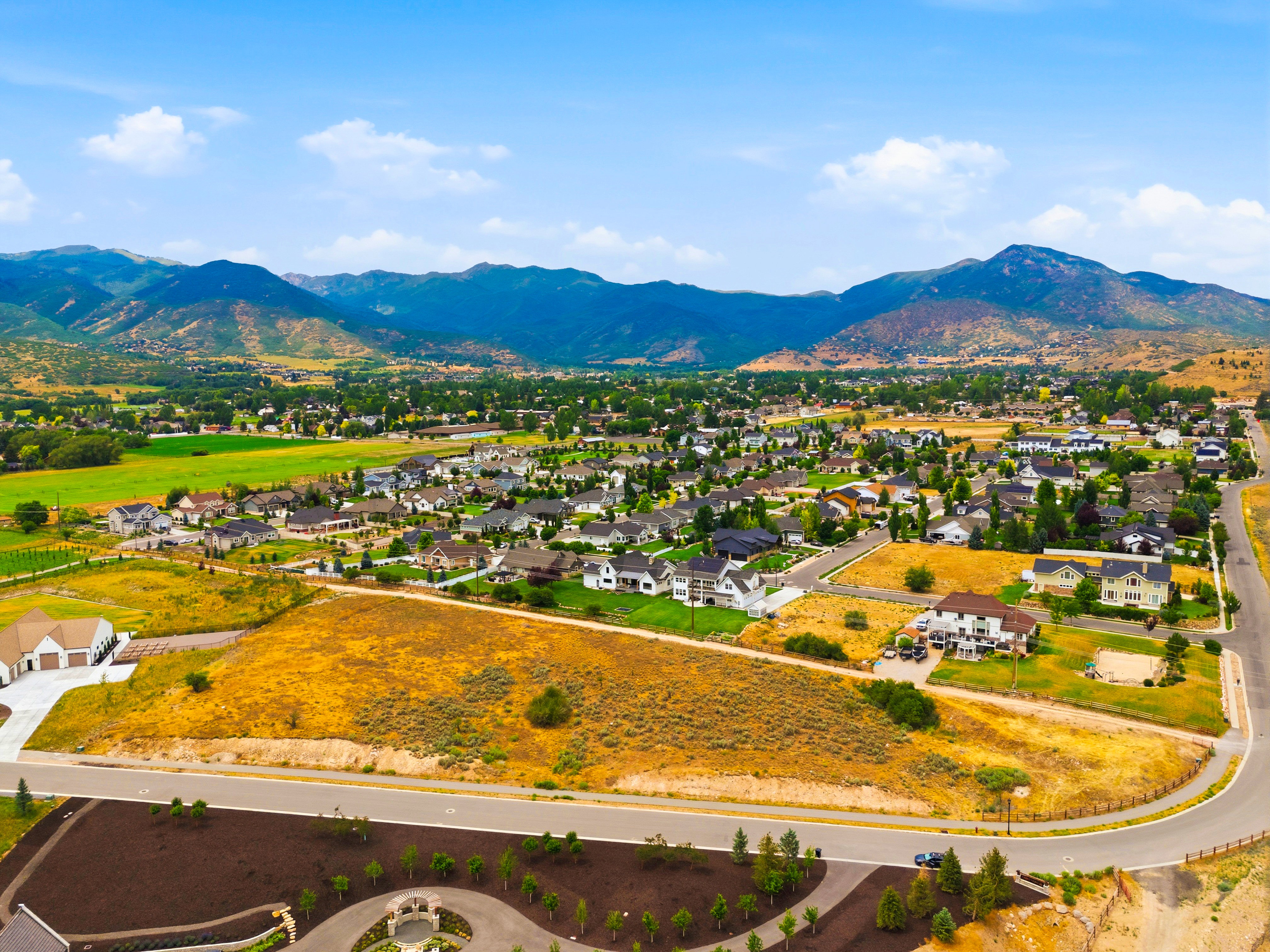 Expansive aerial perspective showcasing a residential development with surrounding natural elements