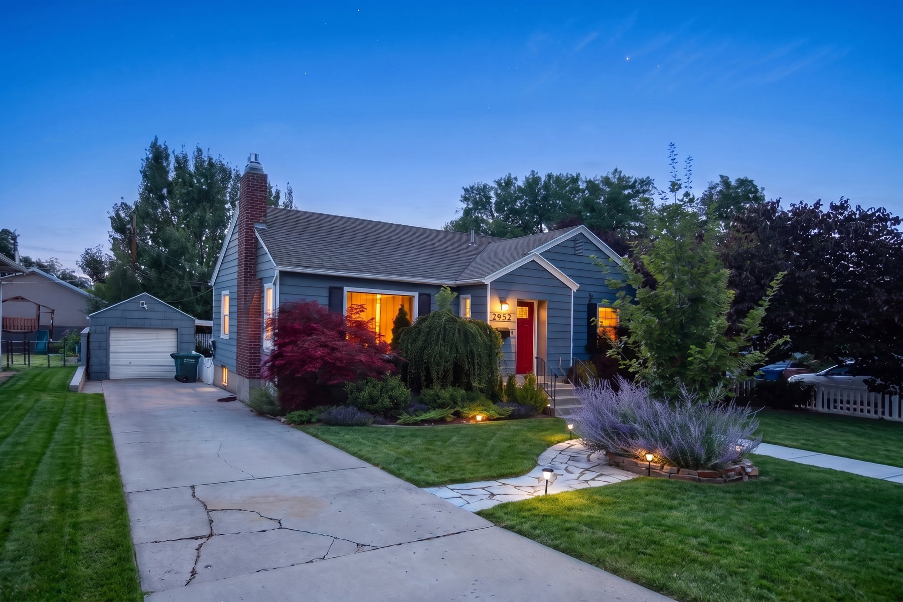 Charming blue exterior with a bright red front door