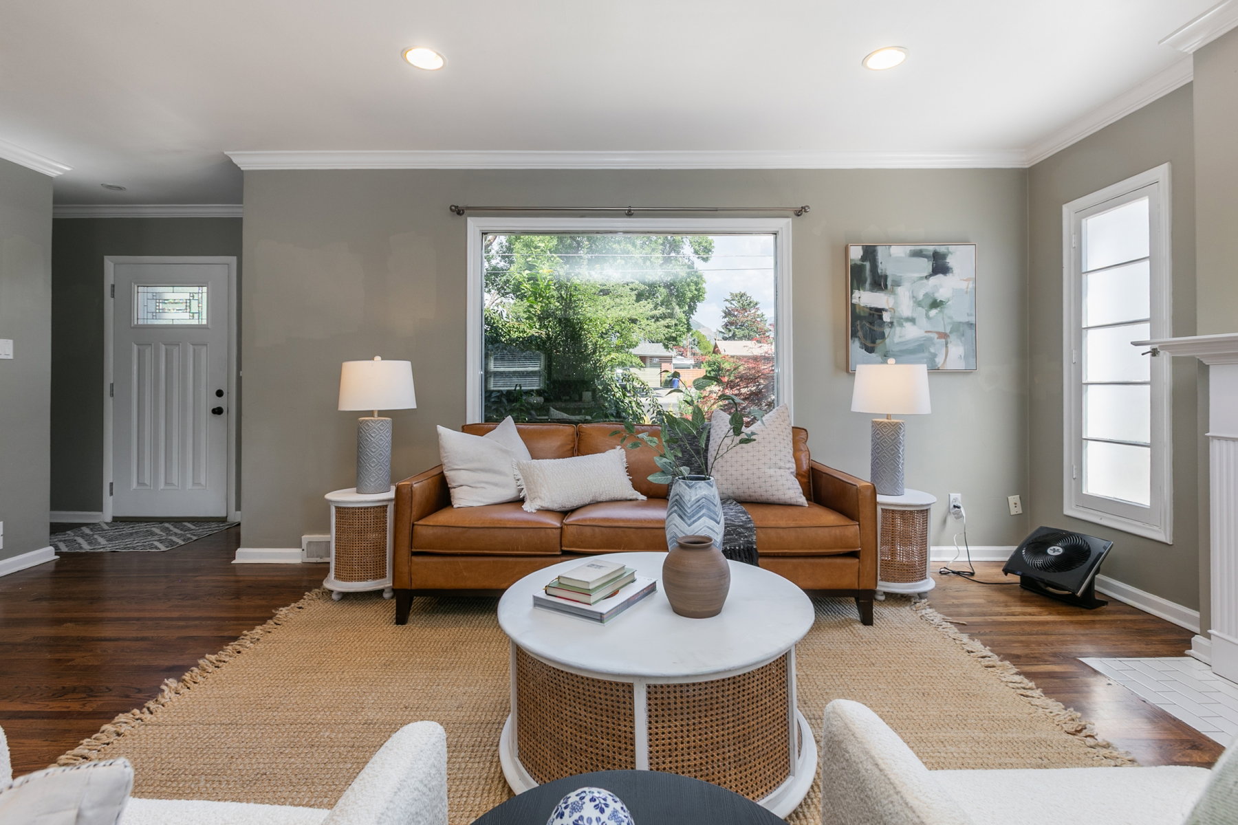 Living area featuring rich wood-finish flooring, recessed lighting, and crown molding
