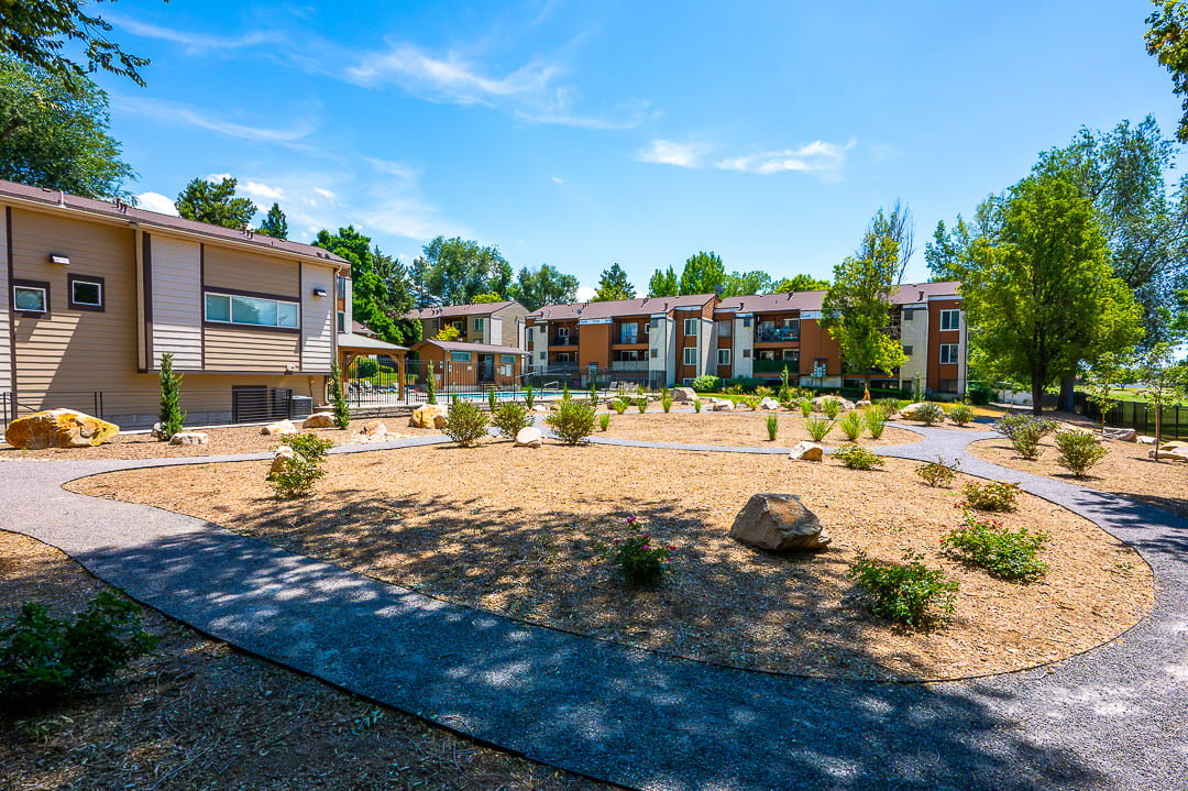 Landscaped community grounds with gravel pathways and mature plantings