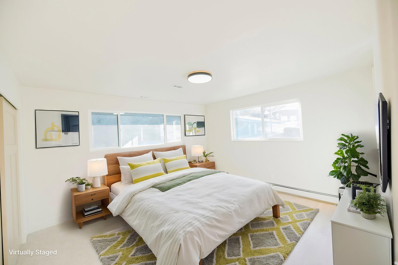 Bright room with light wood-finish flooring, white walls, and a contemporary ceiling light fixture