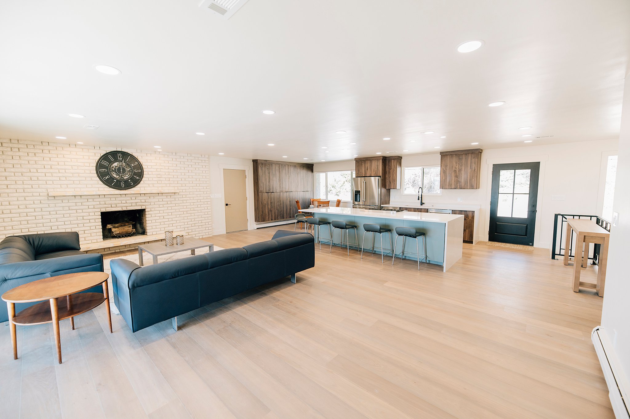 Open-concept living space with light wood-finish flooring