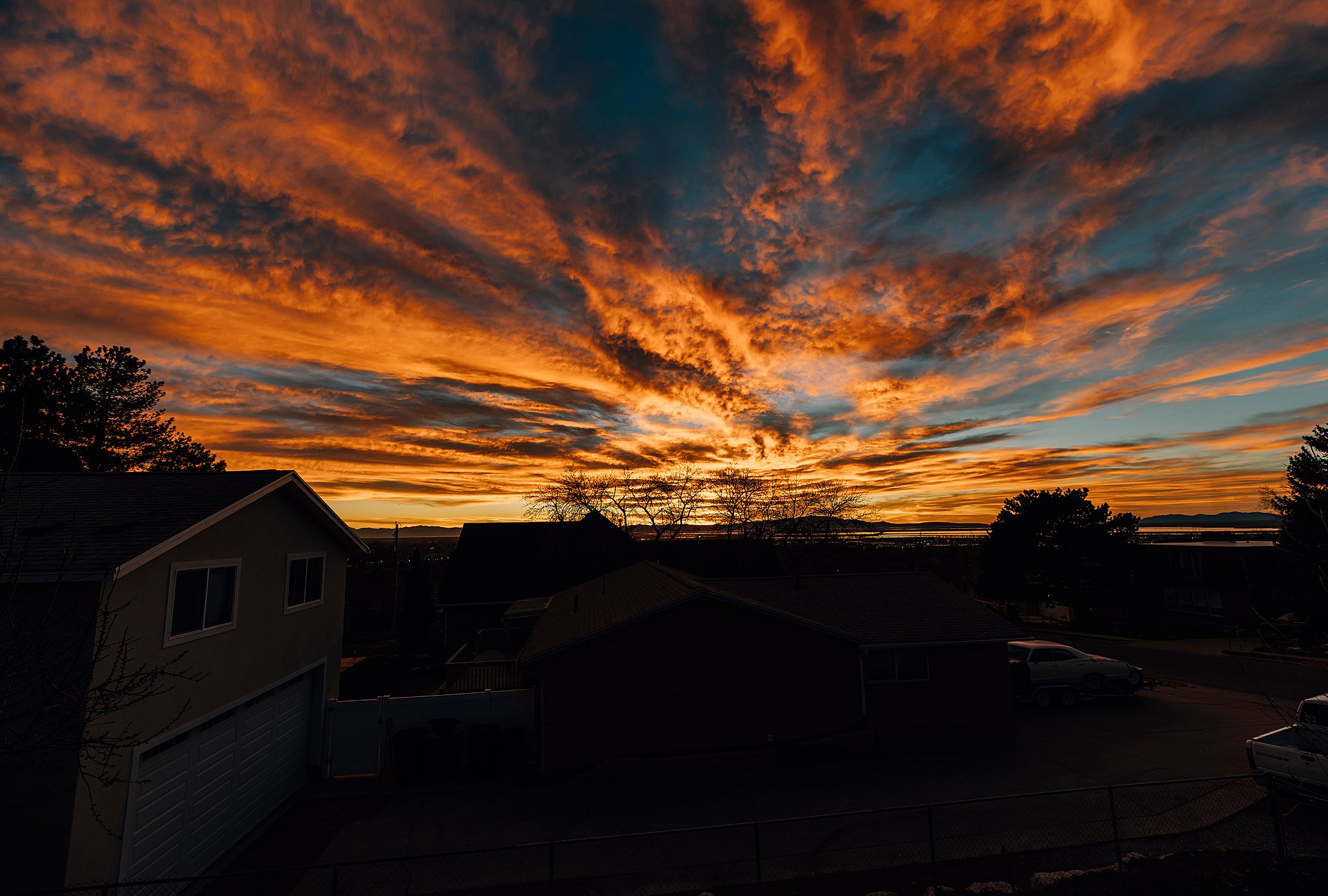 Expansive sky featuring vibrant orange and blue cloud formations