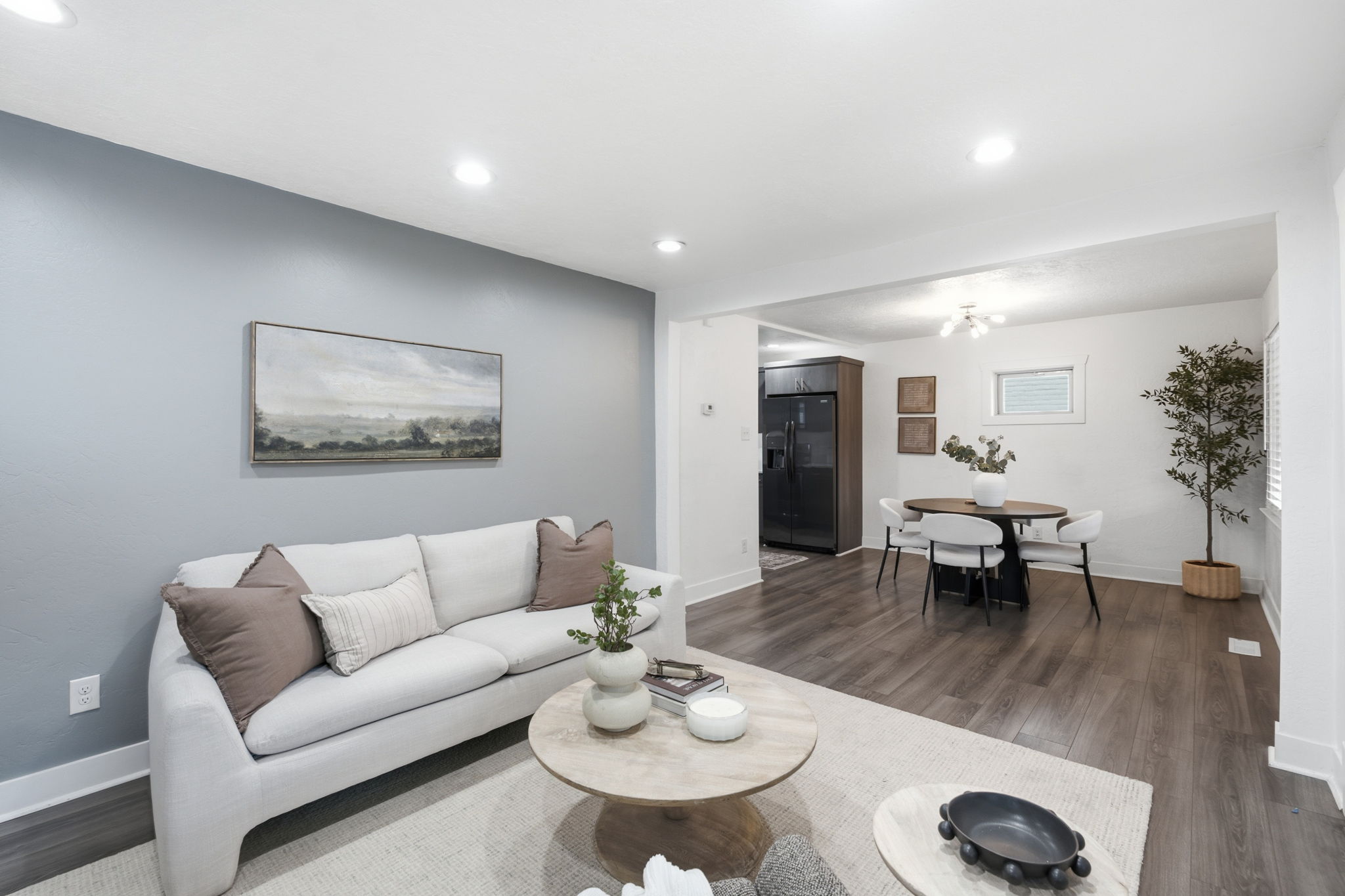 Open-concept living area featuring recessed lighting and wood-finish flooring