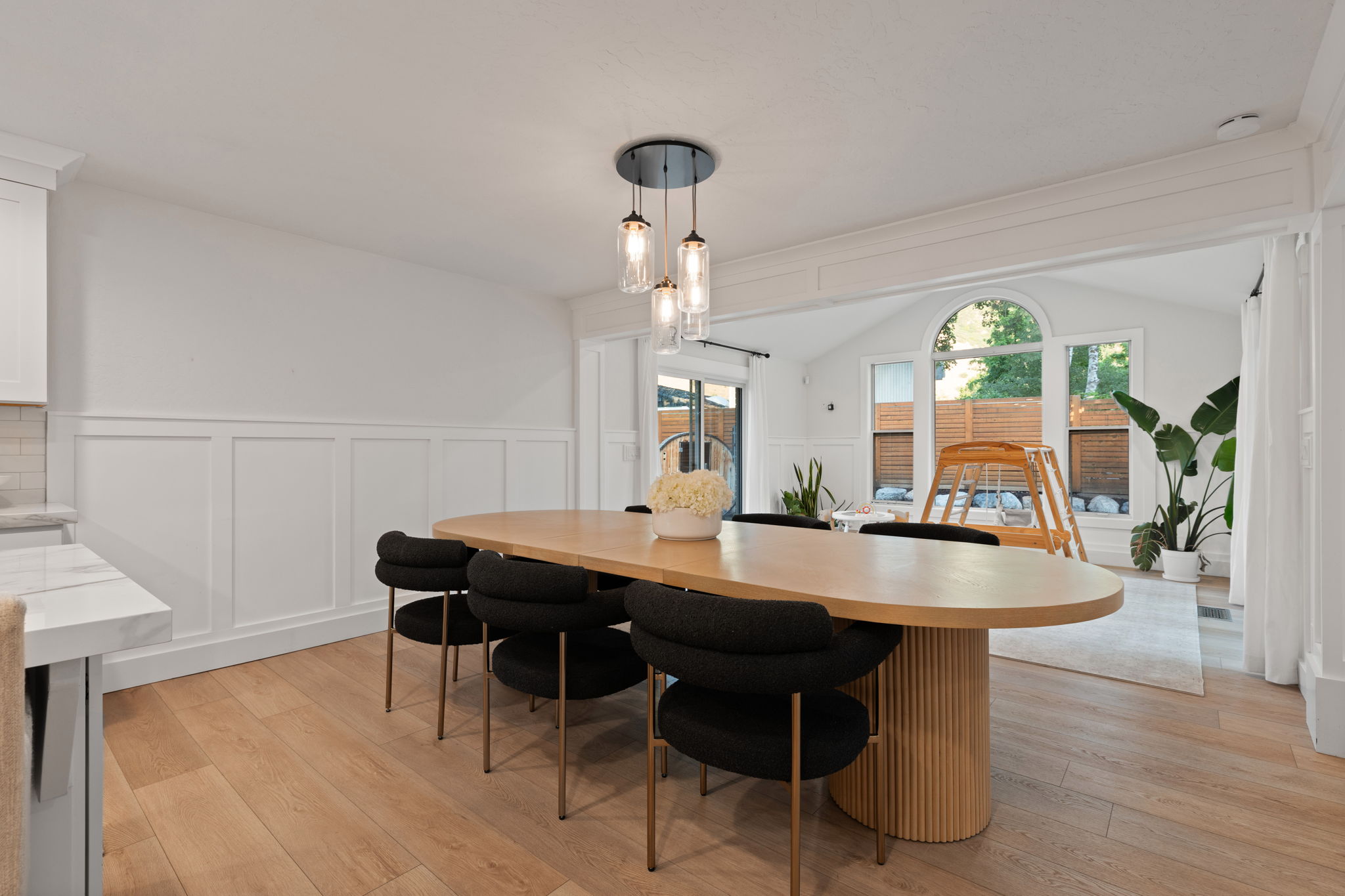 Dining area featuring wood-finish flooring and wainscoting