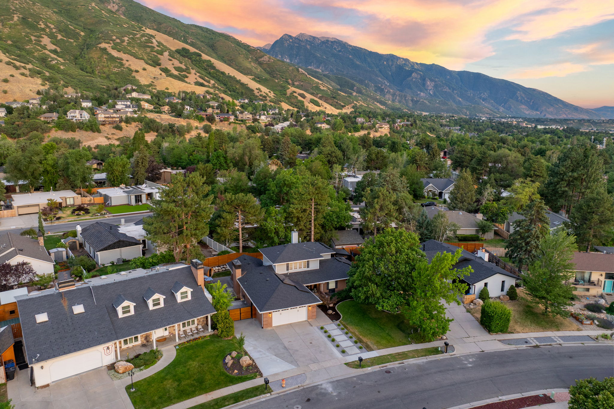 Aerial perspective showcasing a residential neighborhood with mountain backdrop