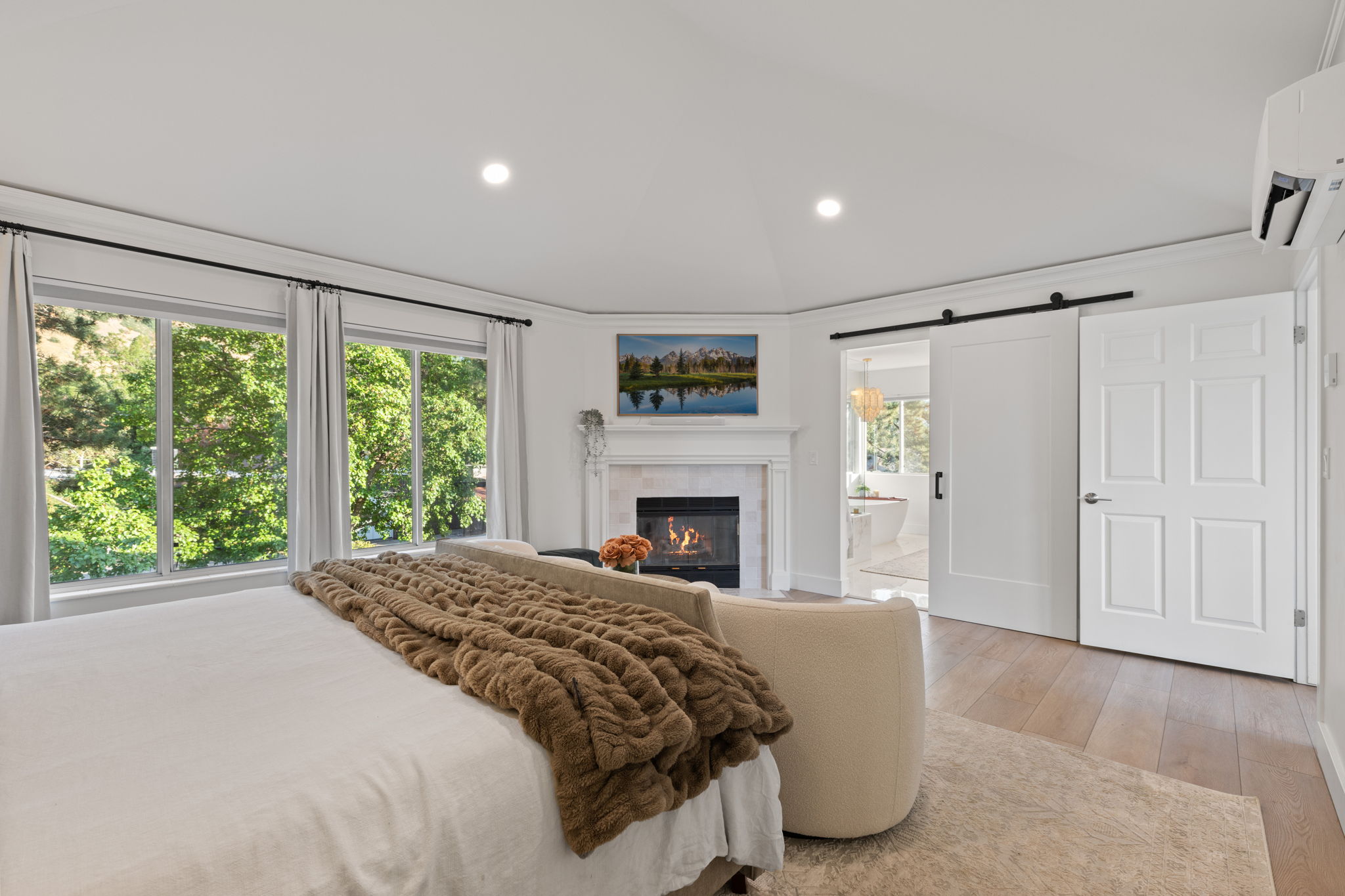 Light wood-finish flooring with a white trim baseboard