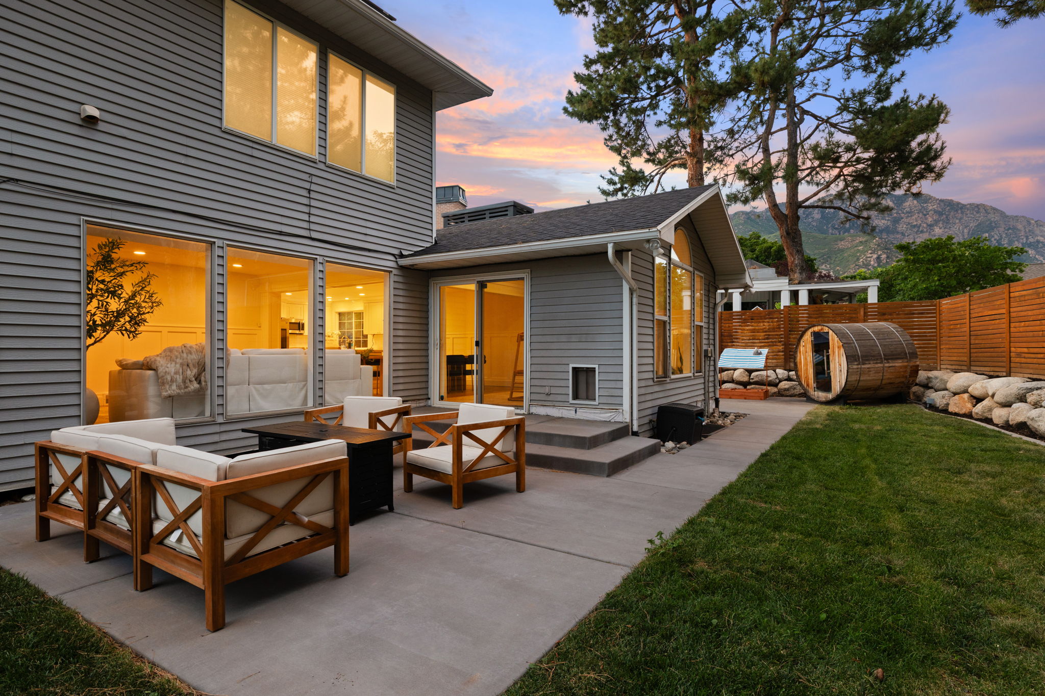 Rear exterior featuring gray horizontal siding and a concrete patio
