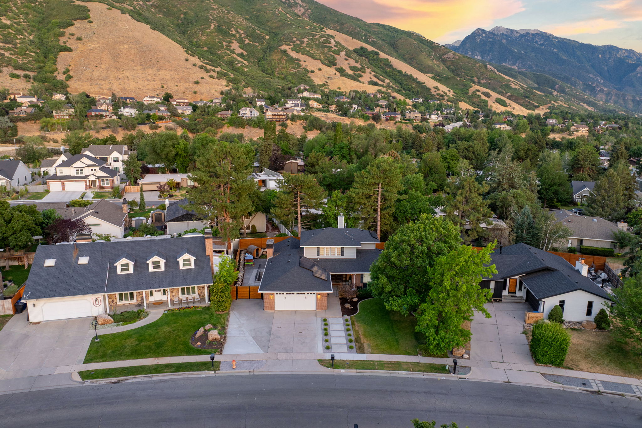 Mature landscaping and mountain backdrop enhance this residential setting