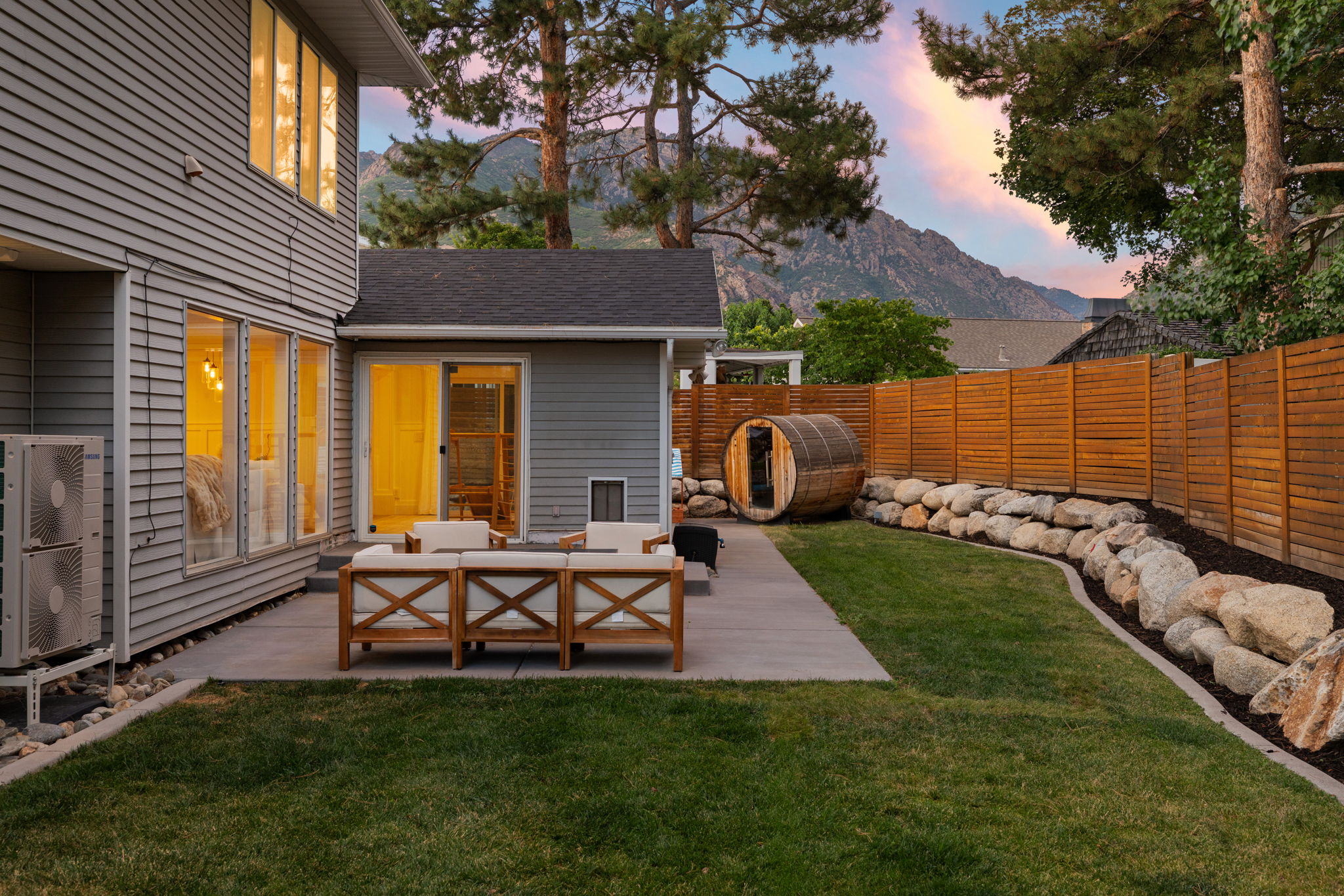 Spacious rear patio featuring a concrete surface and sliding glass door access