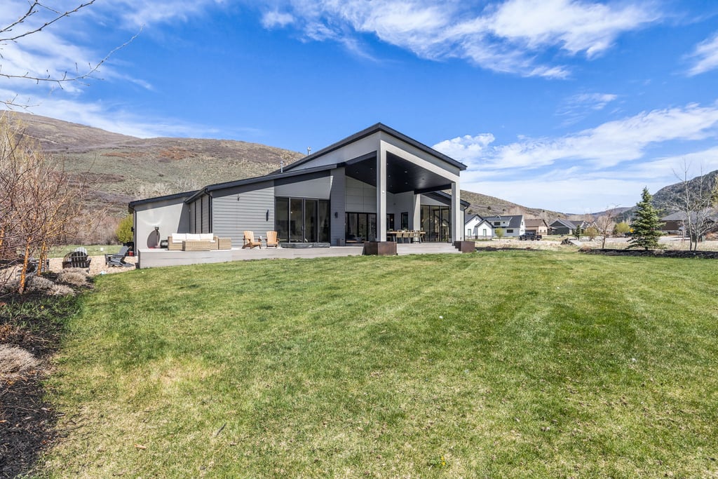 Expansive green lawn bordering a concrete patio