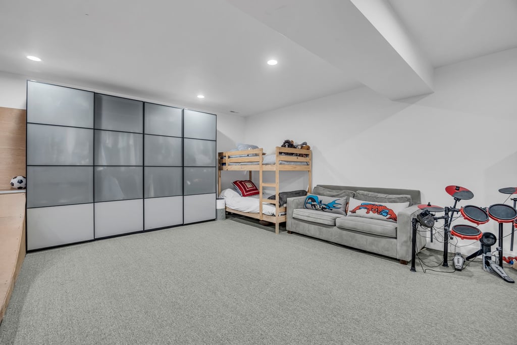 Expansive room featuring light gray carpeting and recessed lighting