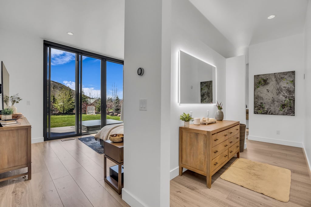 Expansive glass doors opening to a lush green lawn