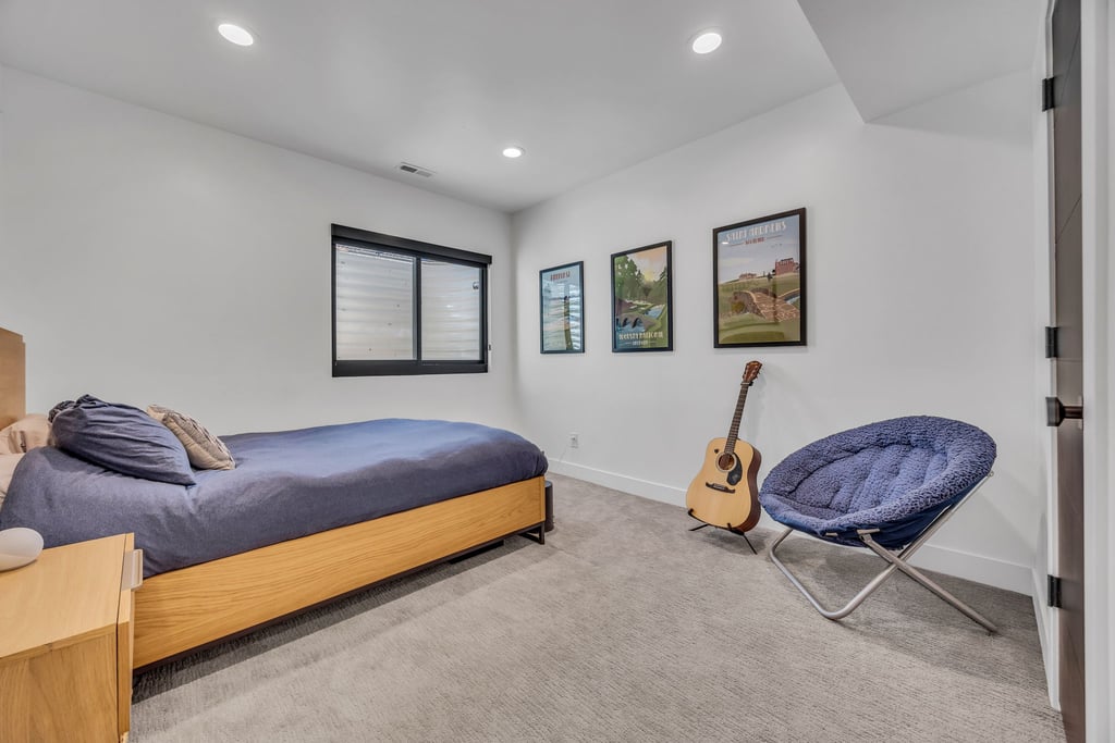 Bedroom featuring a window with integrated blinds, recessed lighting, white walls, and light-colored carpet flooring