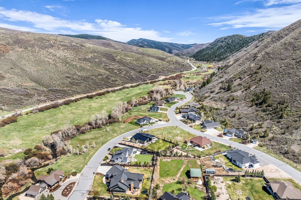 Residential development nestled within a valley surrounded by expansive natural terrain