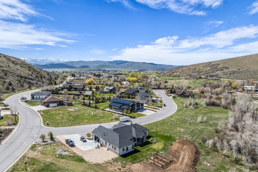 Aerial perspective of a developed neighborhood featuring paved roads and residential structures