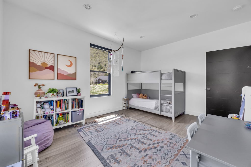 Bright room featuring light wood-finish flooring, white walls, and recessed lighting