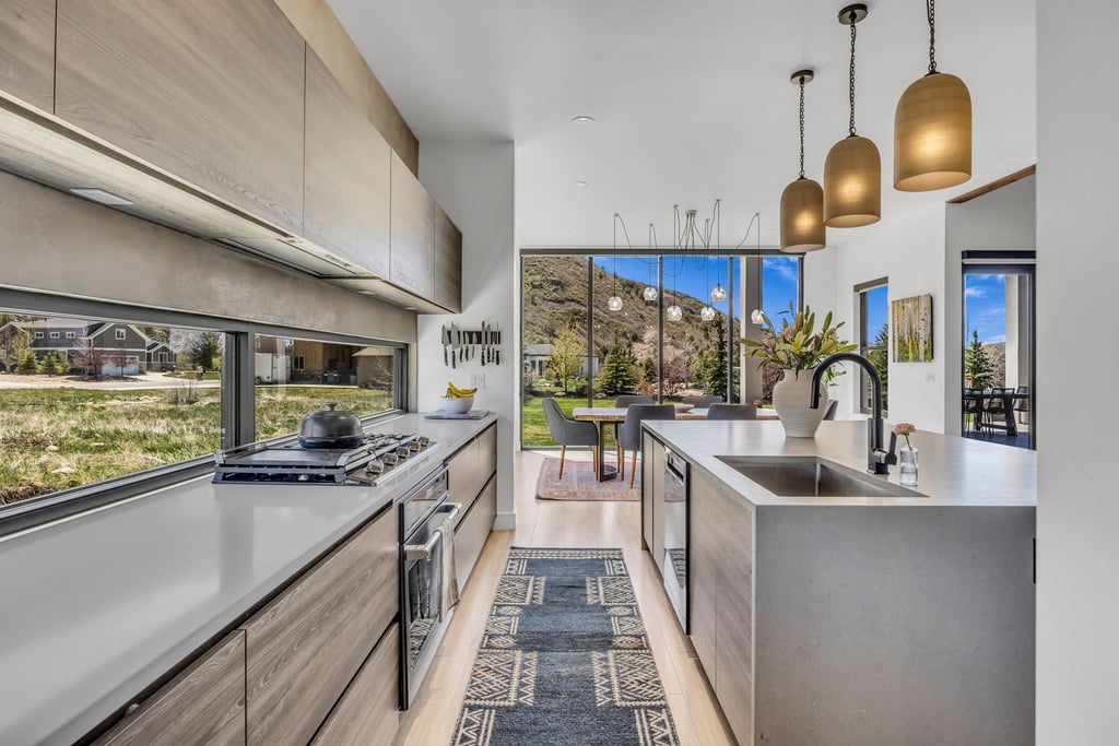 Modern kitchen featuring light wood-finish cabinetry and light countertops