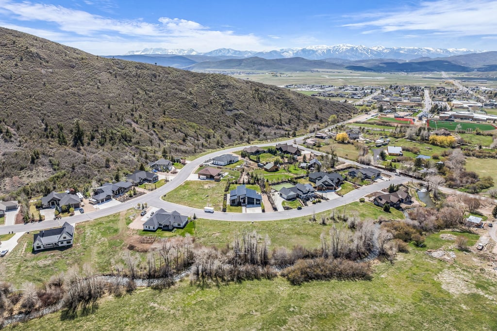 Aerial perspective showcasing a residential development nestled against a natural hillside