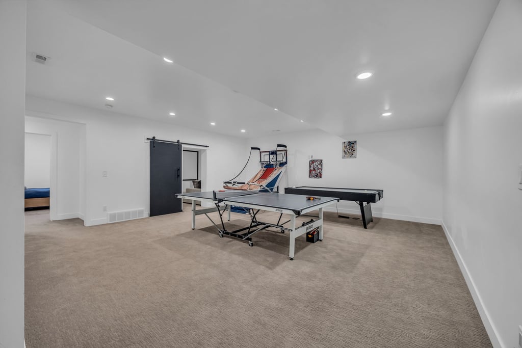 Expansive carpeted room featuring recessed lighting and white walls
