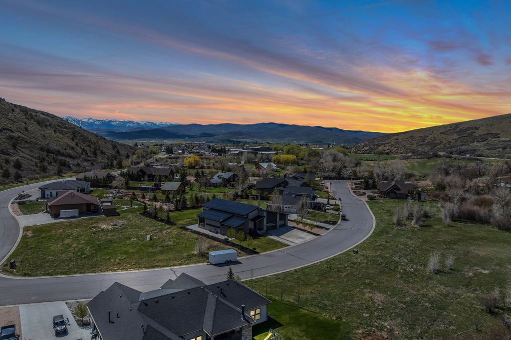 Aerial perspective of a developed residential area with paved streets and established homes