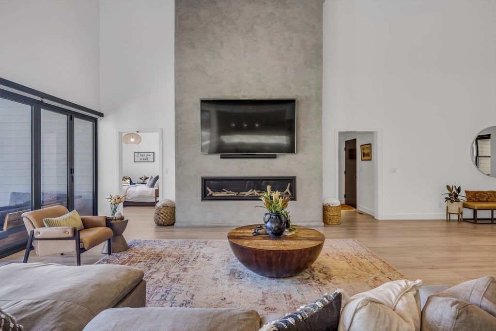 Living area featuring a floor-to-ceiling textured fireplace surround with an inset linear fireplace