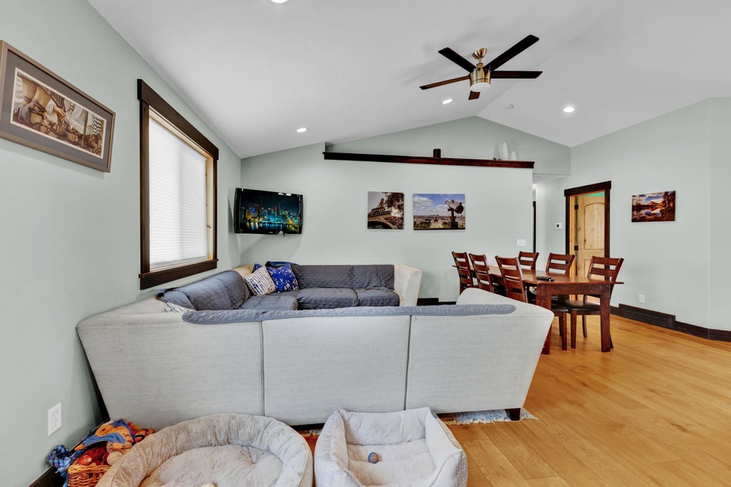 Expansive living area with high vaulted ceilings and recessed lighting