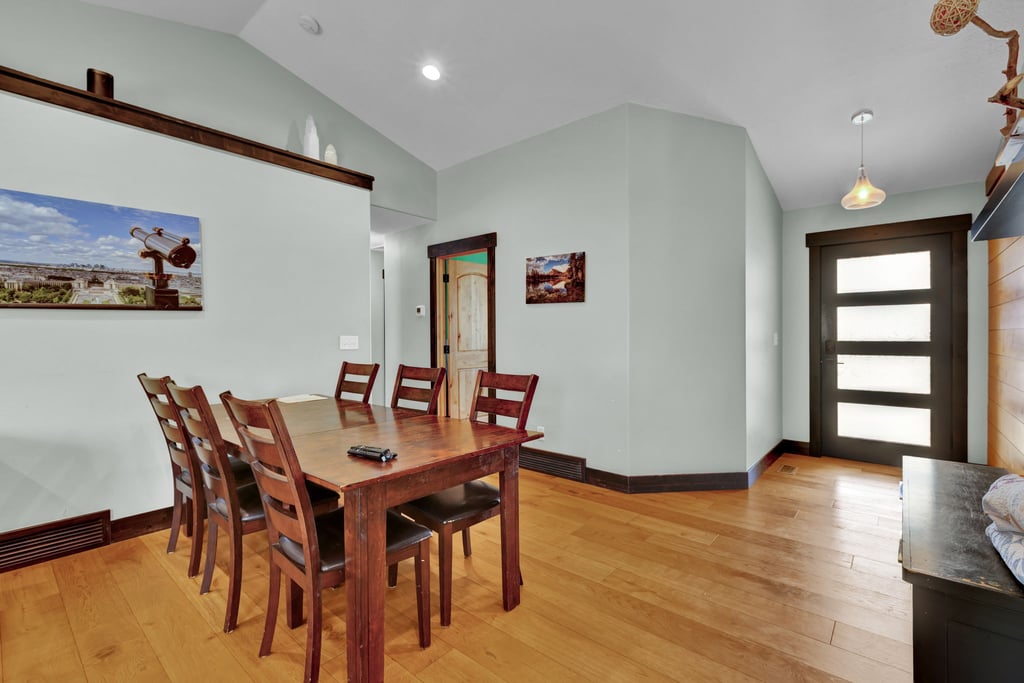 Light wood-finish flooring complements the pale blue walls and dark wood trim