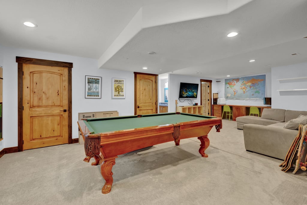 Recreation room featuring recessed lighting, a built-in media center, and two solid wood panel doors with dark trim