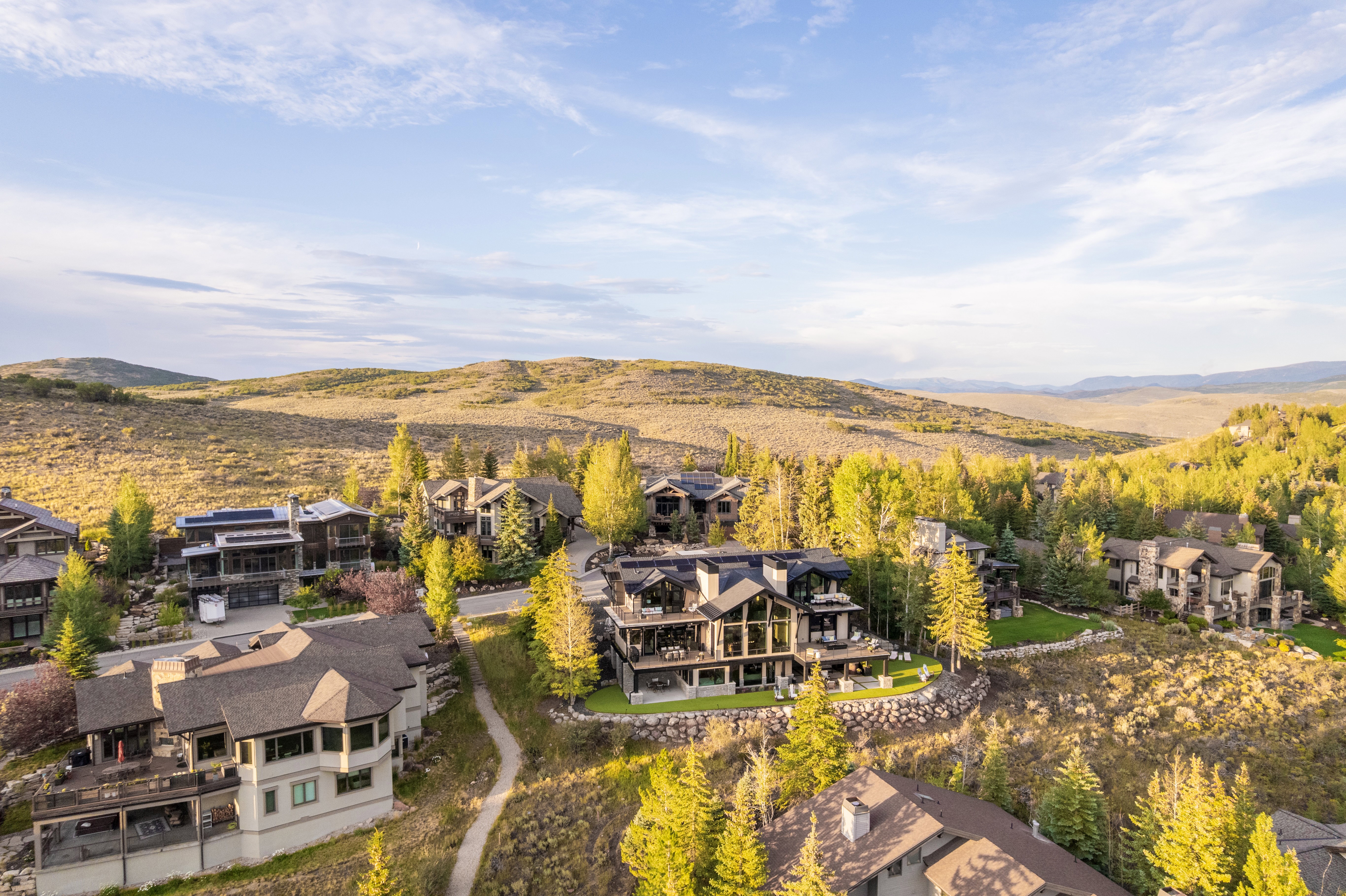 Elevated homesites showcasing varied architectural styles with extensive landscaping