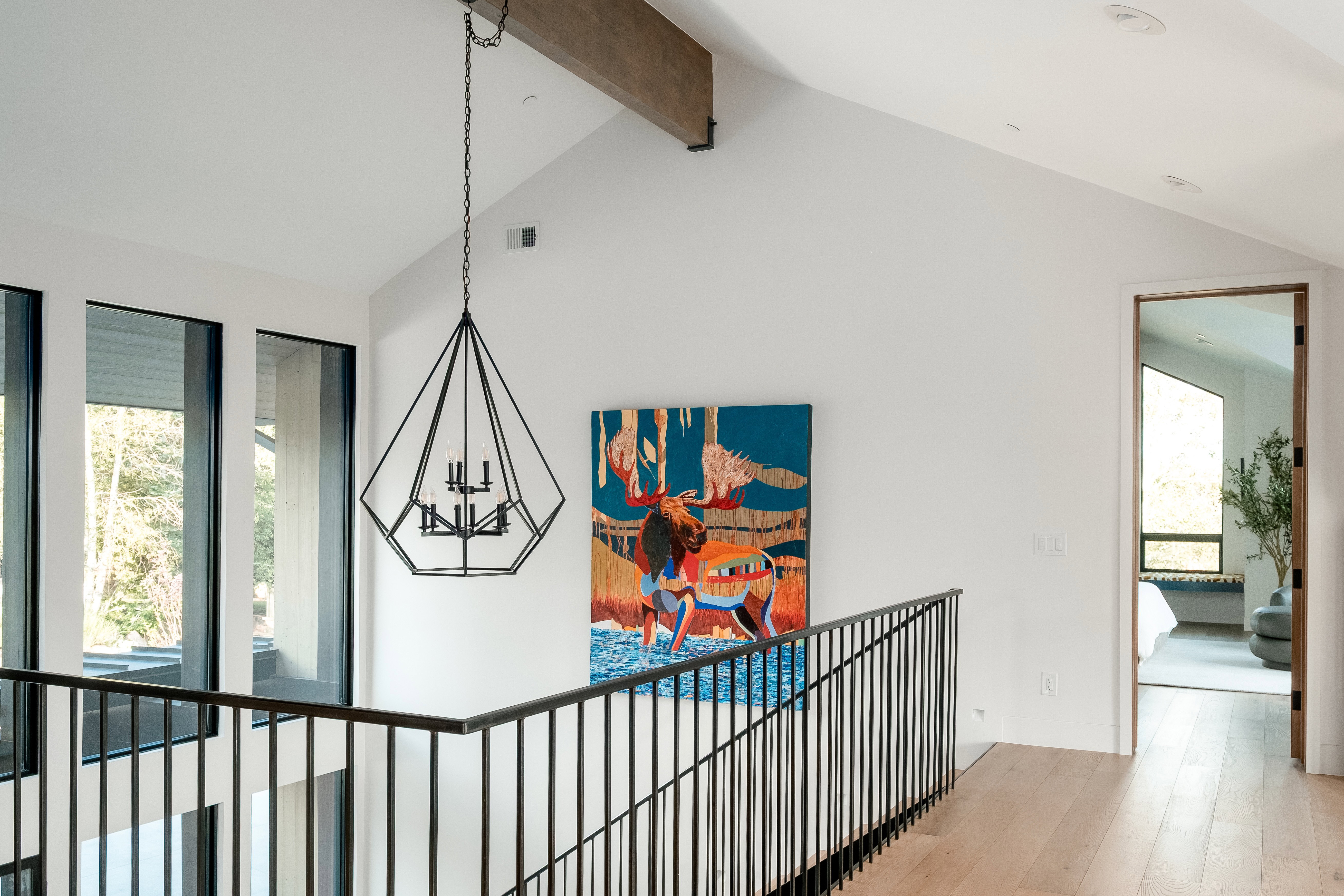 Vaulted ceiling with exposed wood beam and recessed lighting
