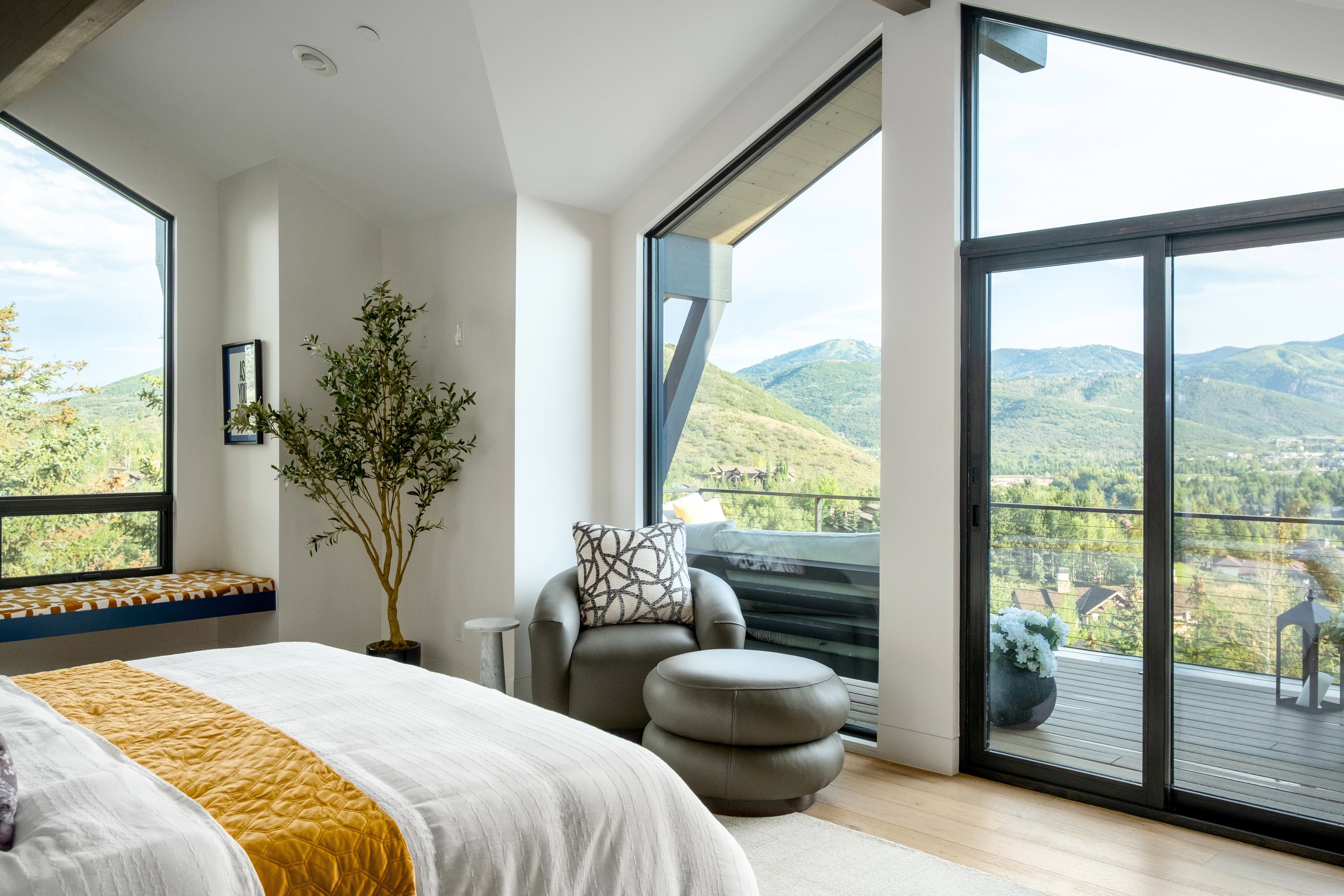 Expansive windows and sliding glass doors offer abundant natural light and mountain scenery