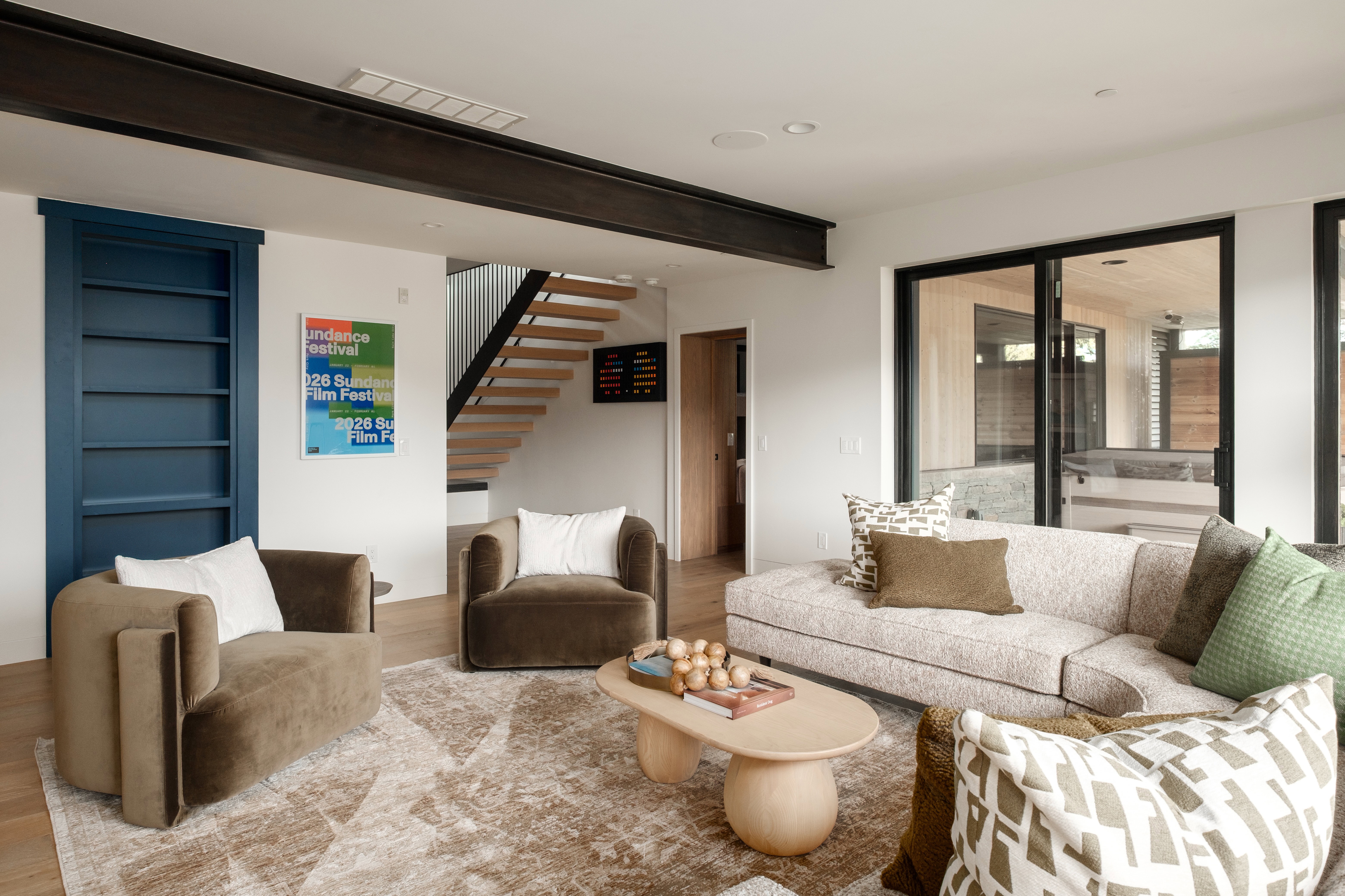 Open-concept living area featuring wood-finish flooring and a large area rug