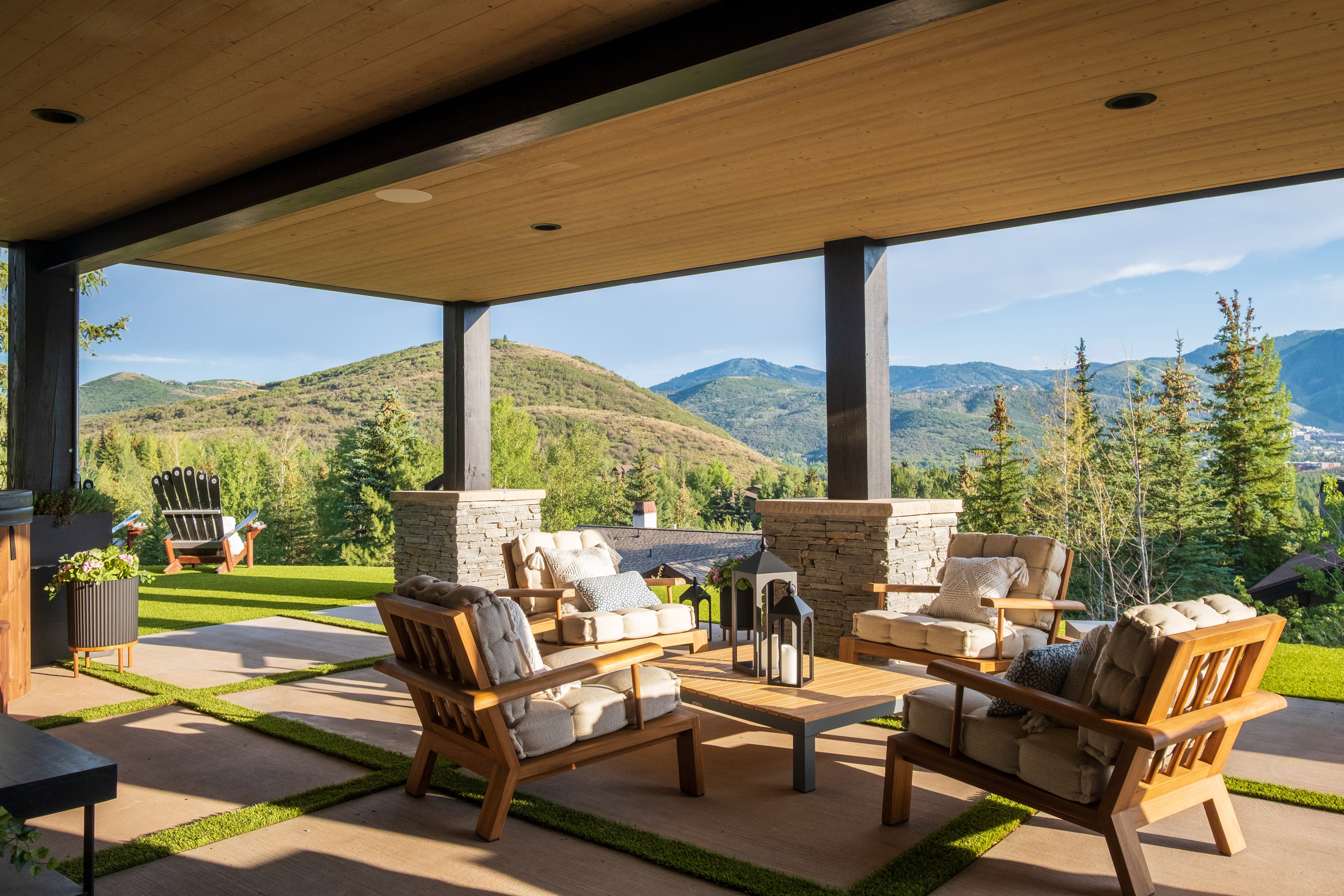 Covered patio featuring a wood-finish ceiling, recessed lighting, and stone-clad pillars