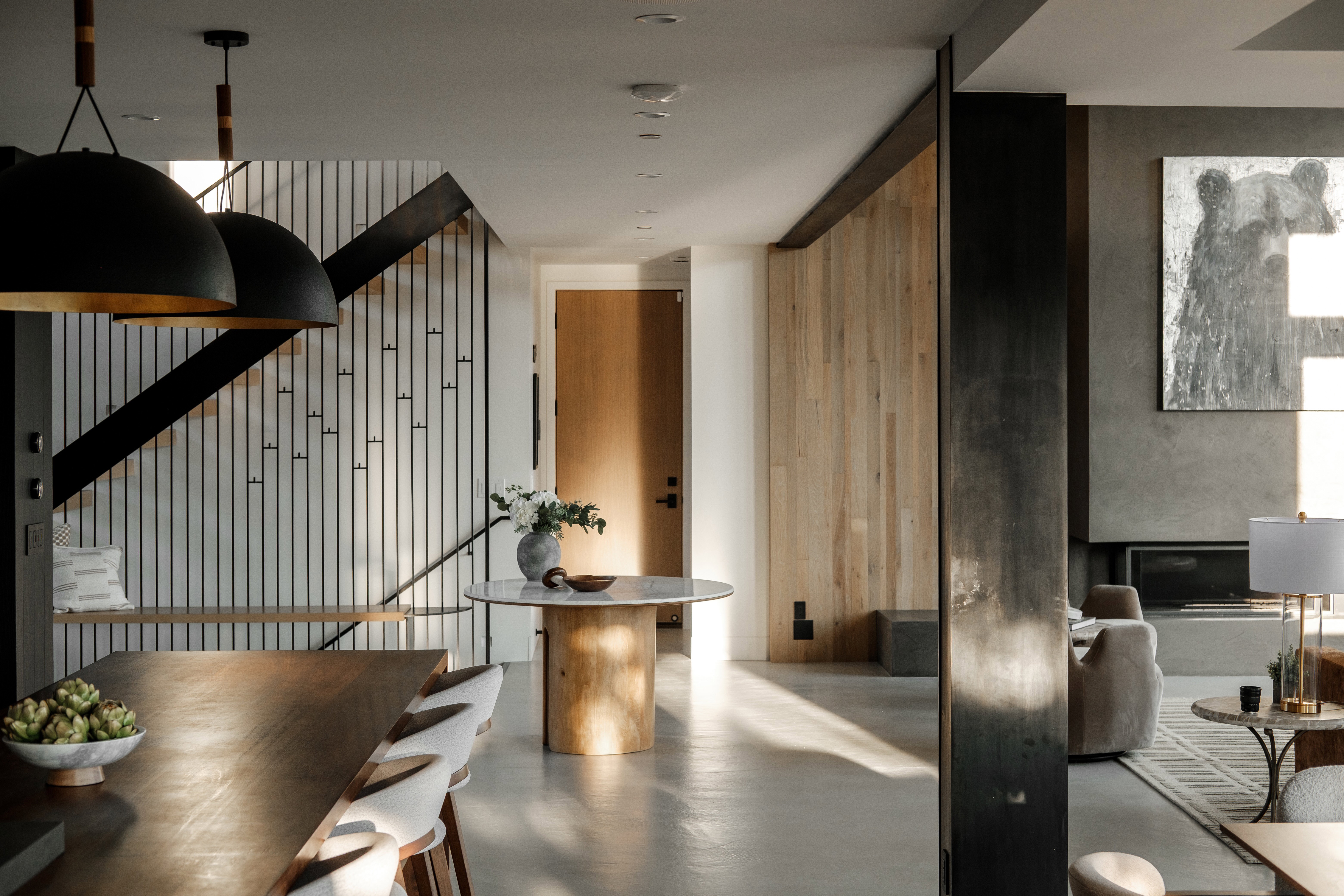 Open-concept interior featuring light wood-finish flooring and a wood slat accent wall