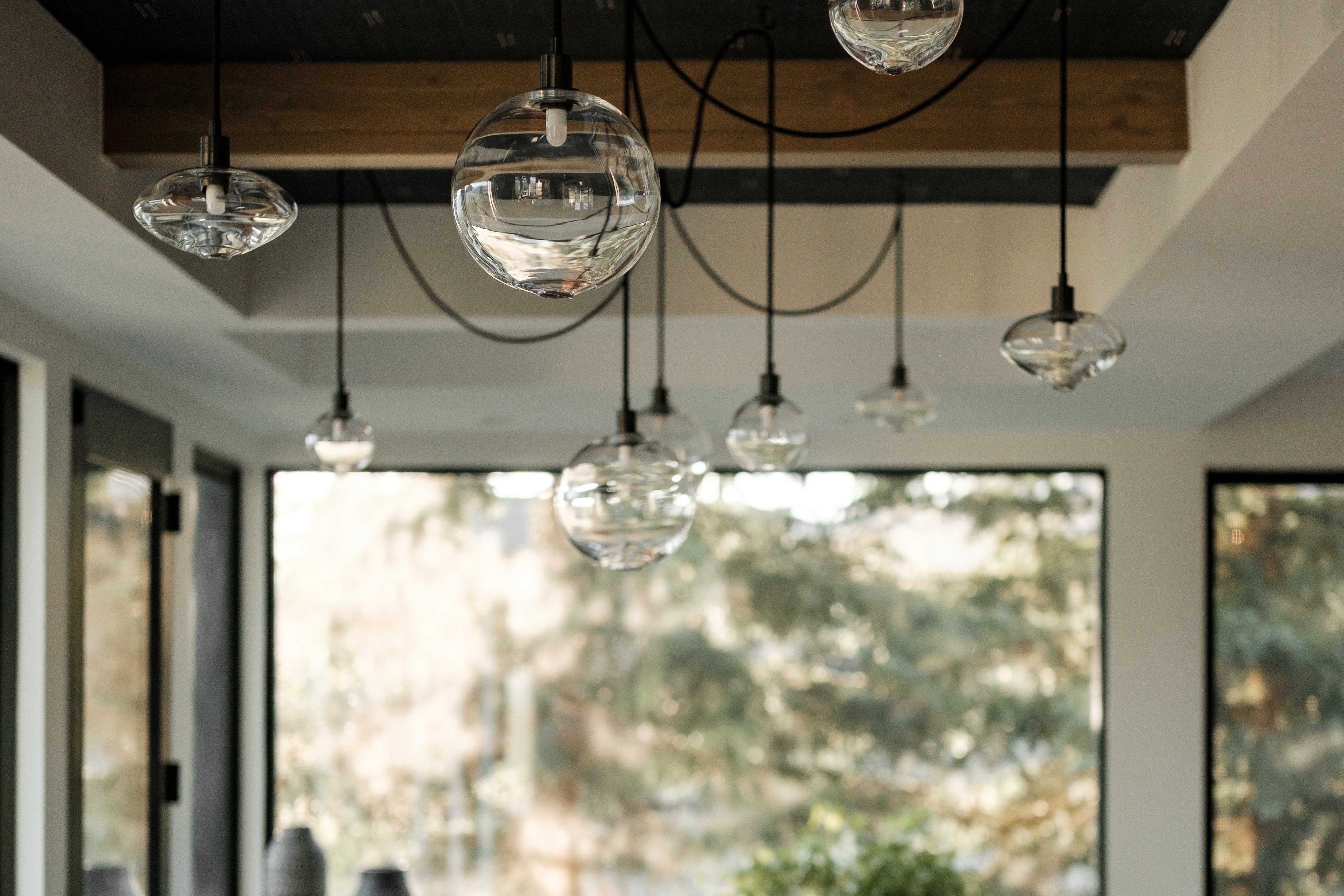 Contemporary glass pendant lighting fixture featuring multiple clear globes