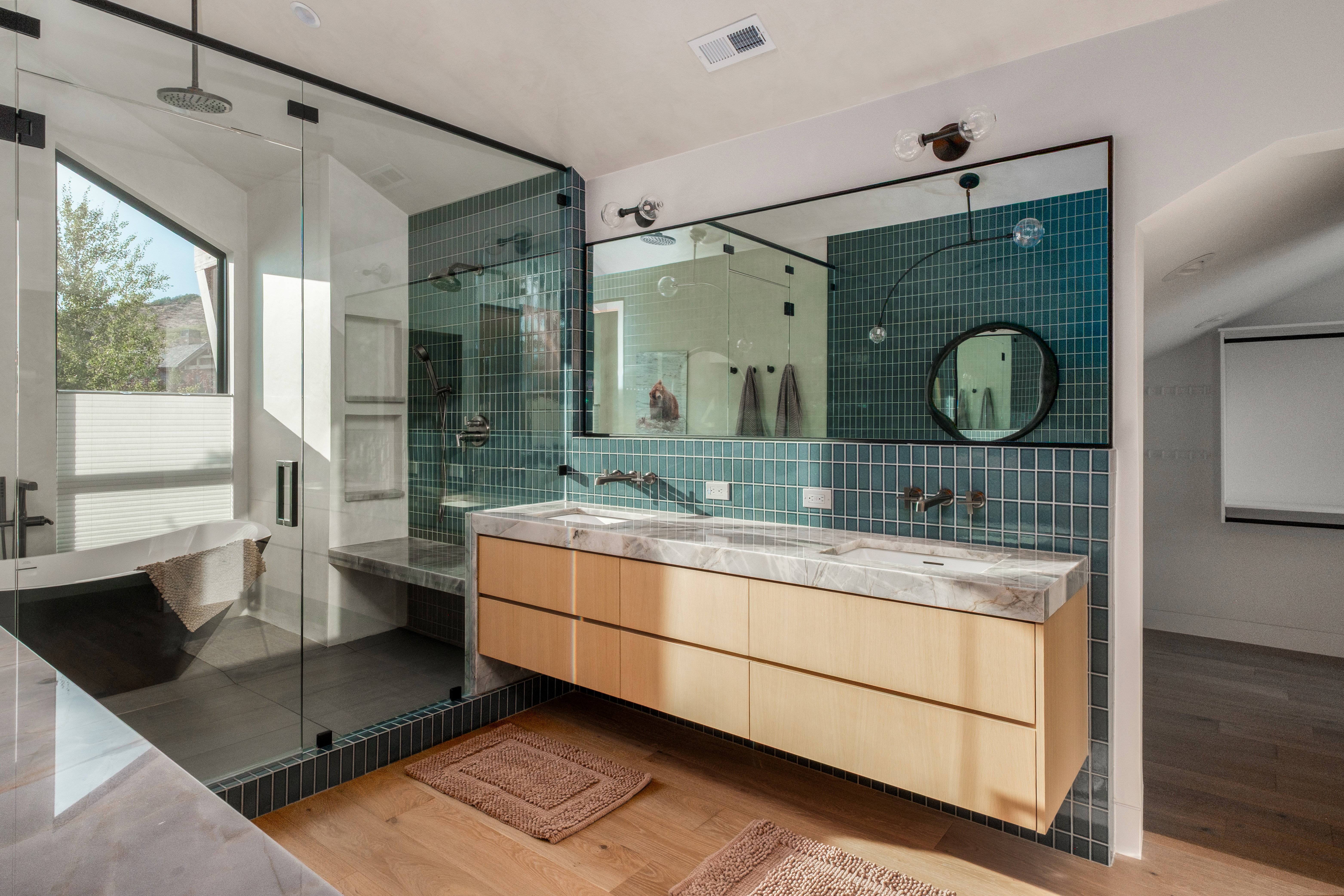 Modern bathroom featuring a dual vanity with wood-finish cabinetry and stone countertops