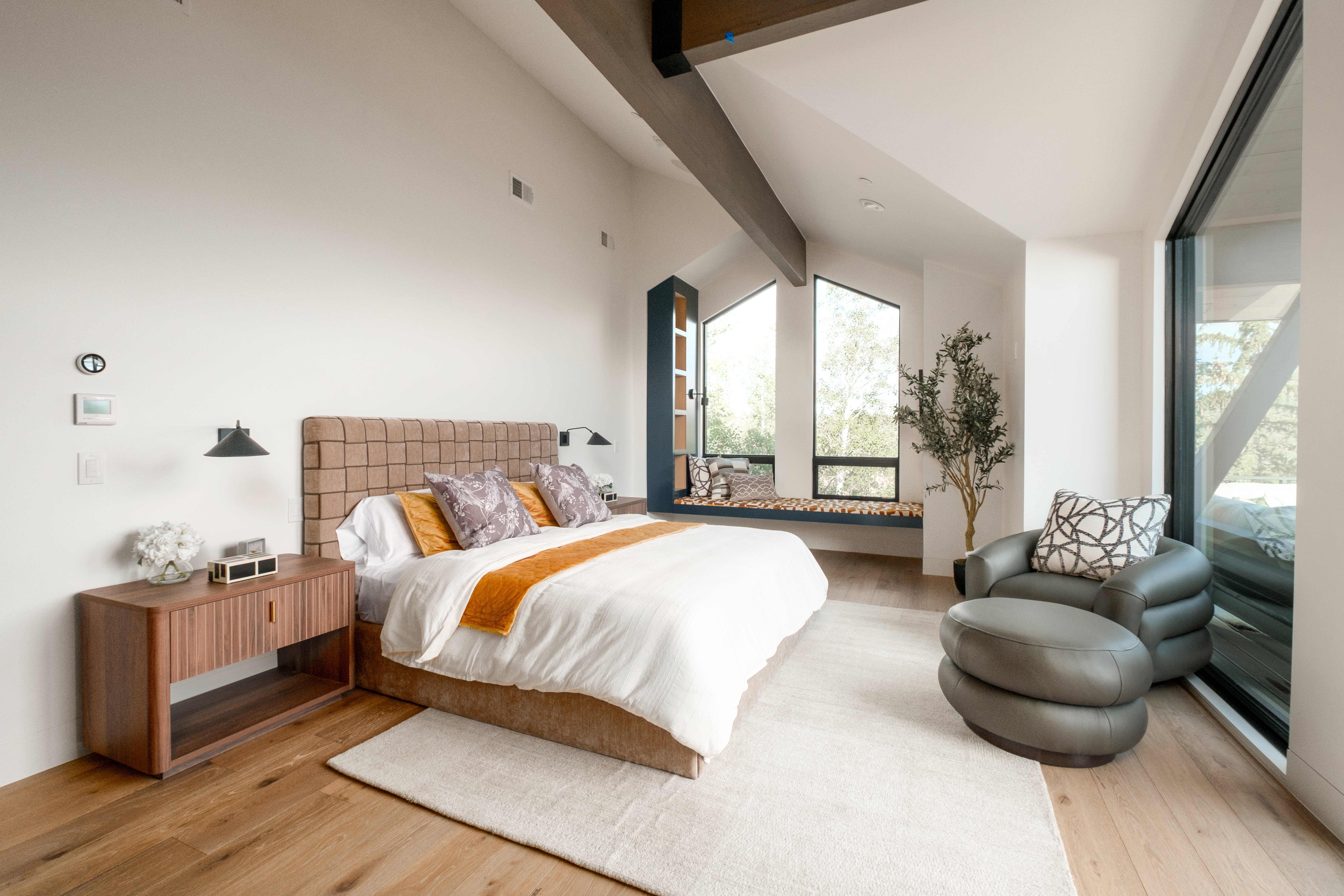 Vaulted ceilings with exposed beams complement the wood-finish flooring