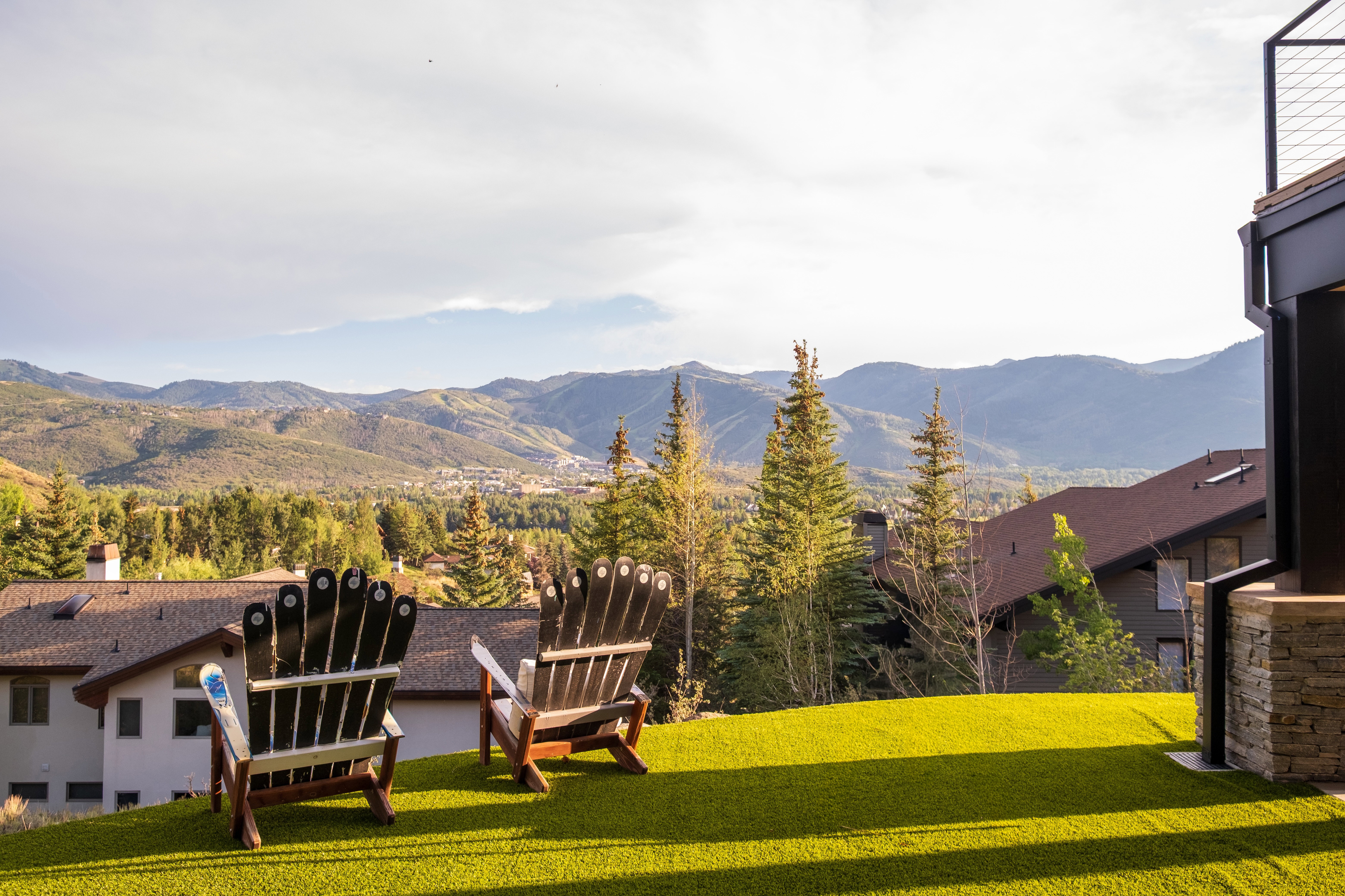 Expansive outdoor space featuring green turf and mountain scenery
