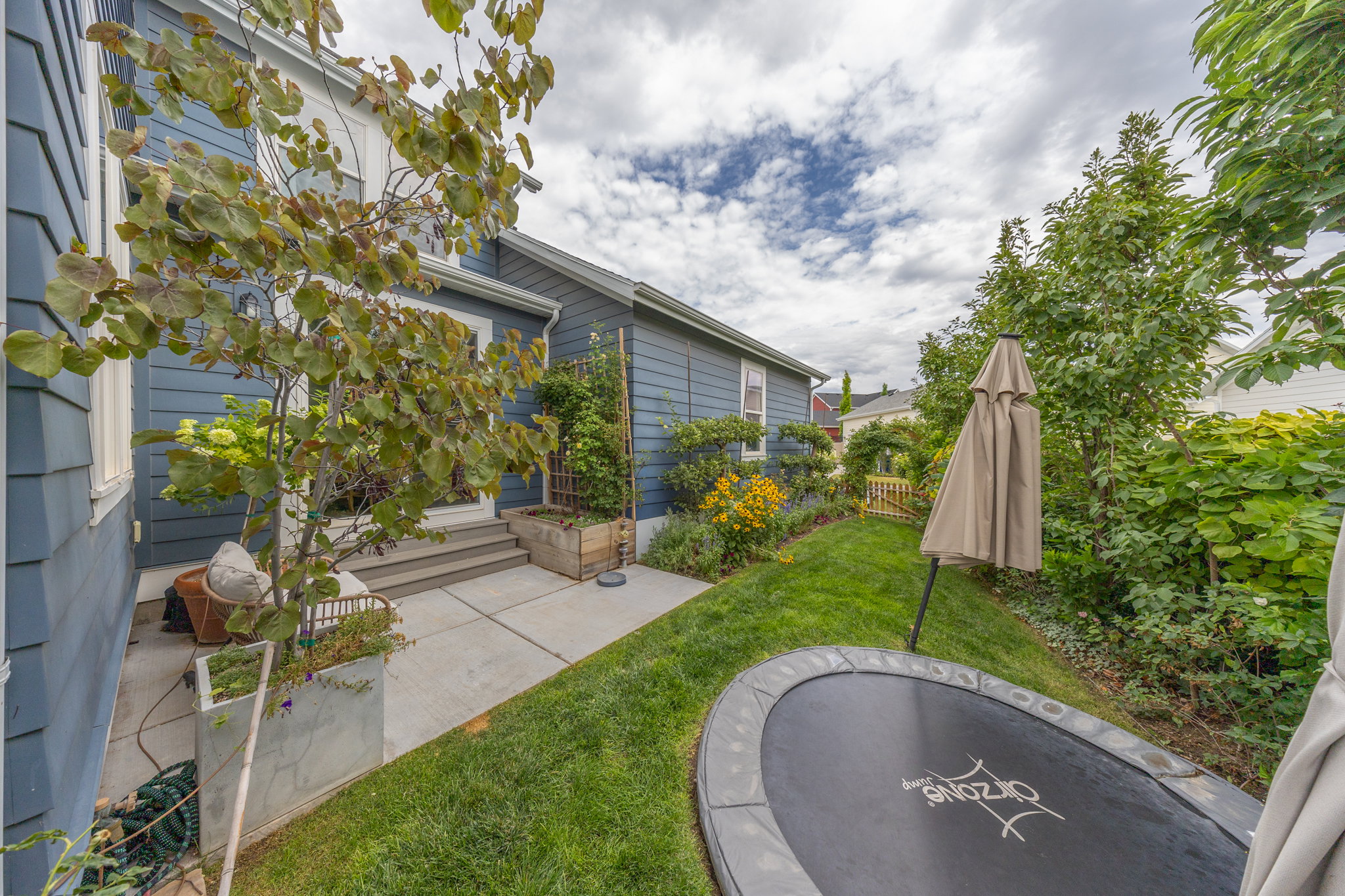 Exterior features blue siding with white trim