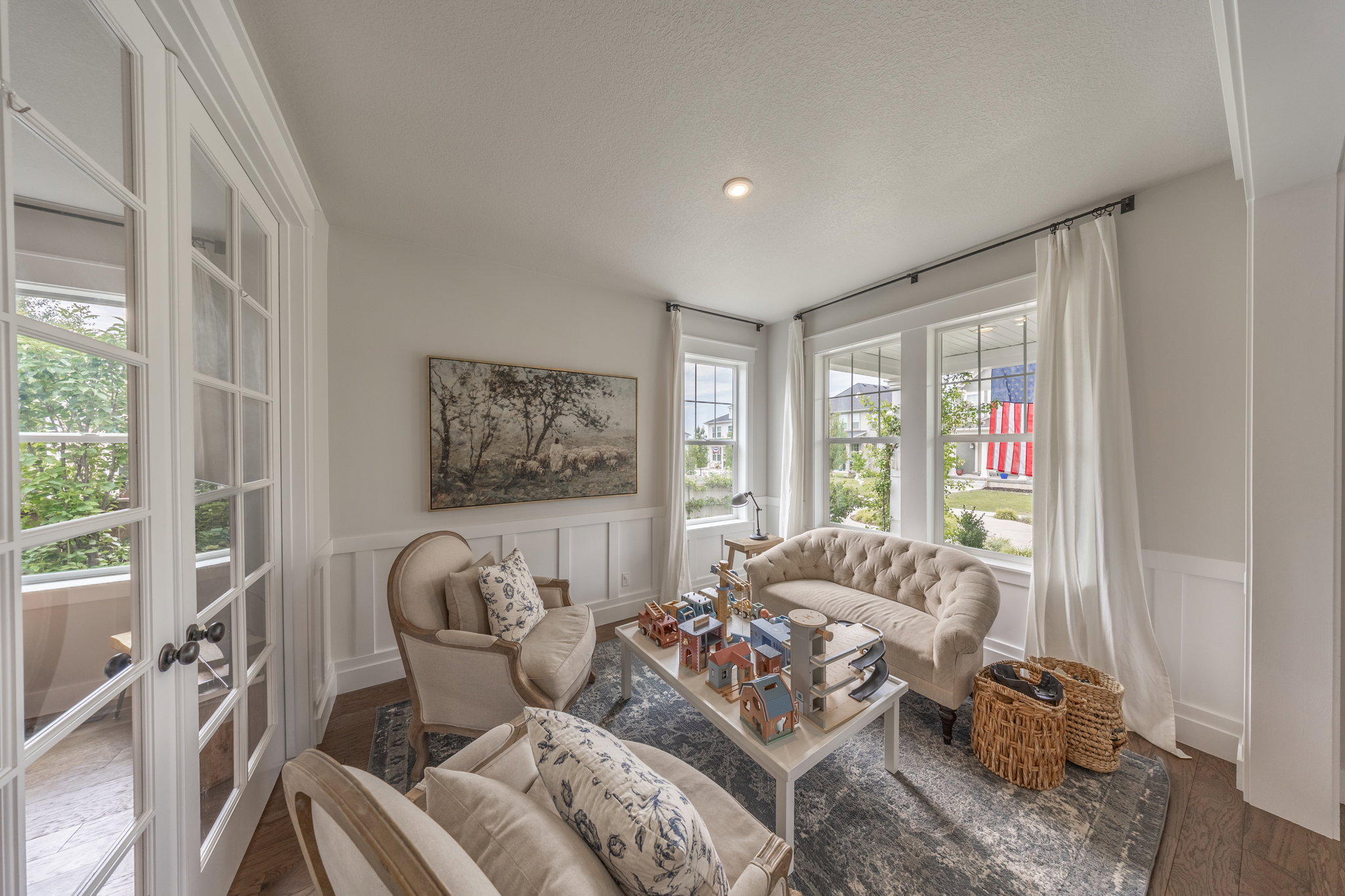 Interior room featuring white wainscoting and multiple windows