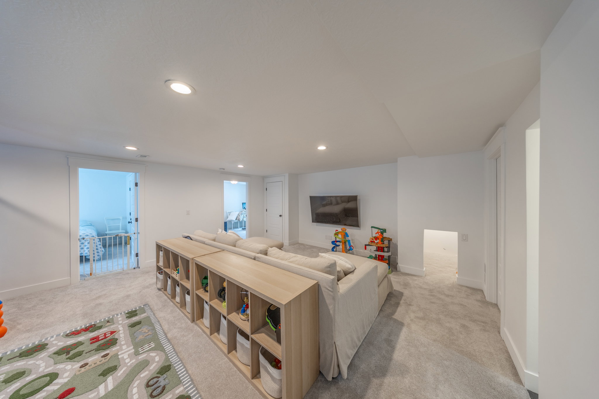 Spacious carpeted room featuring recessed lighting, white walls, and white trim